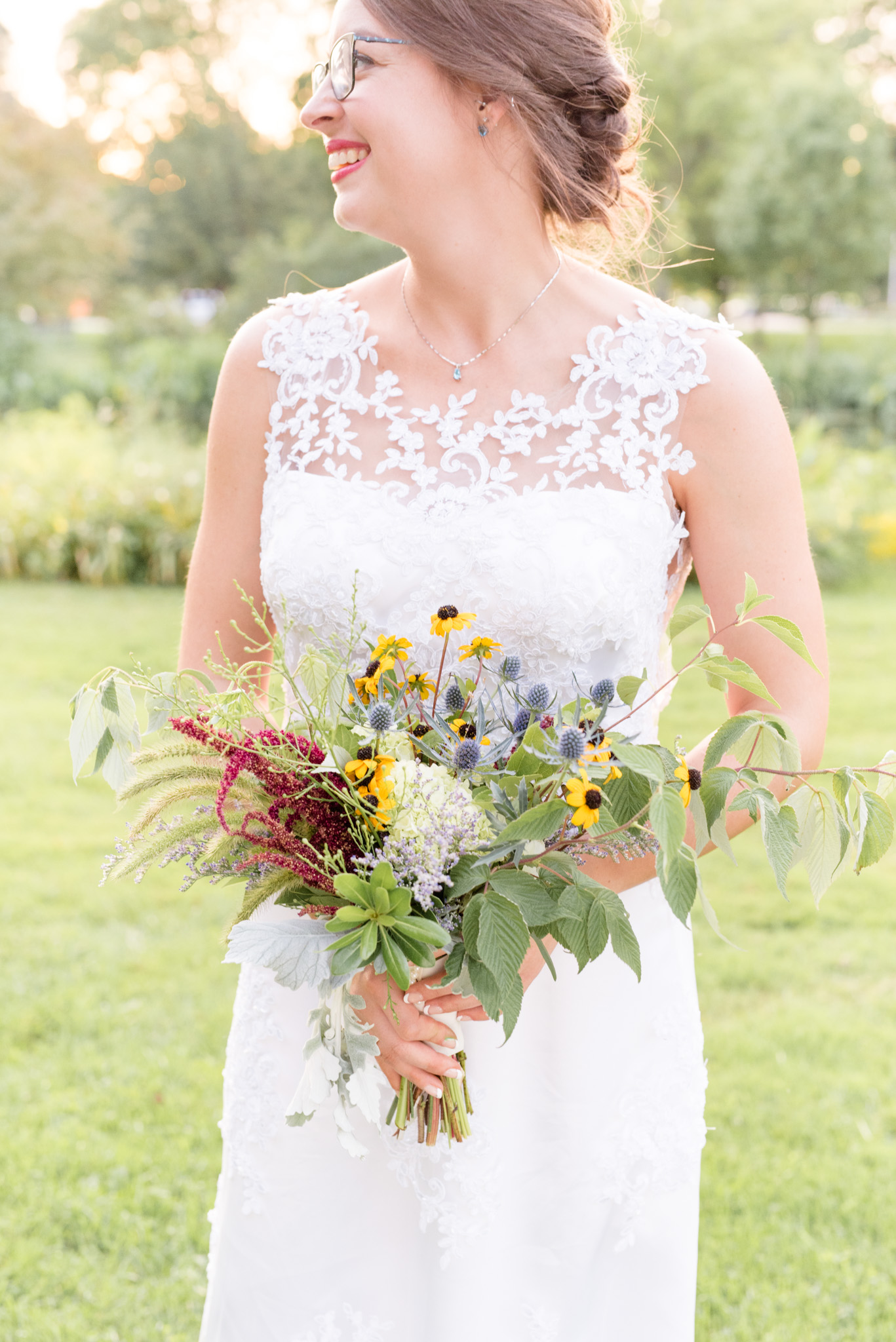 Bride holds bouquet.