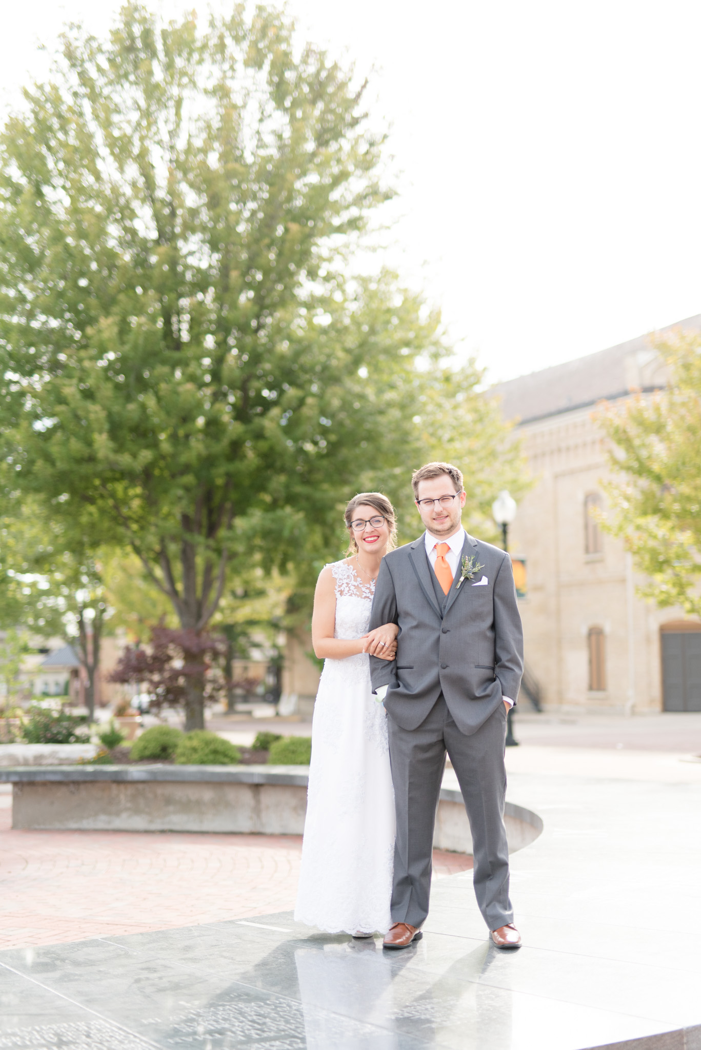 Bride and groom smile at camera.