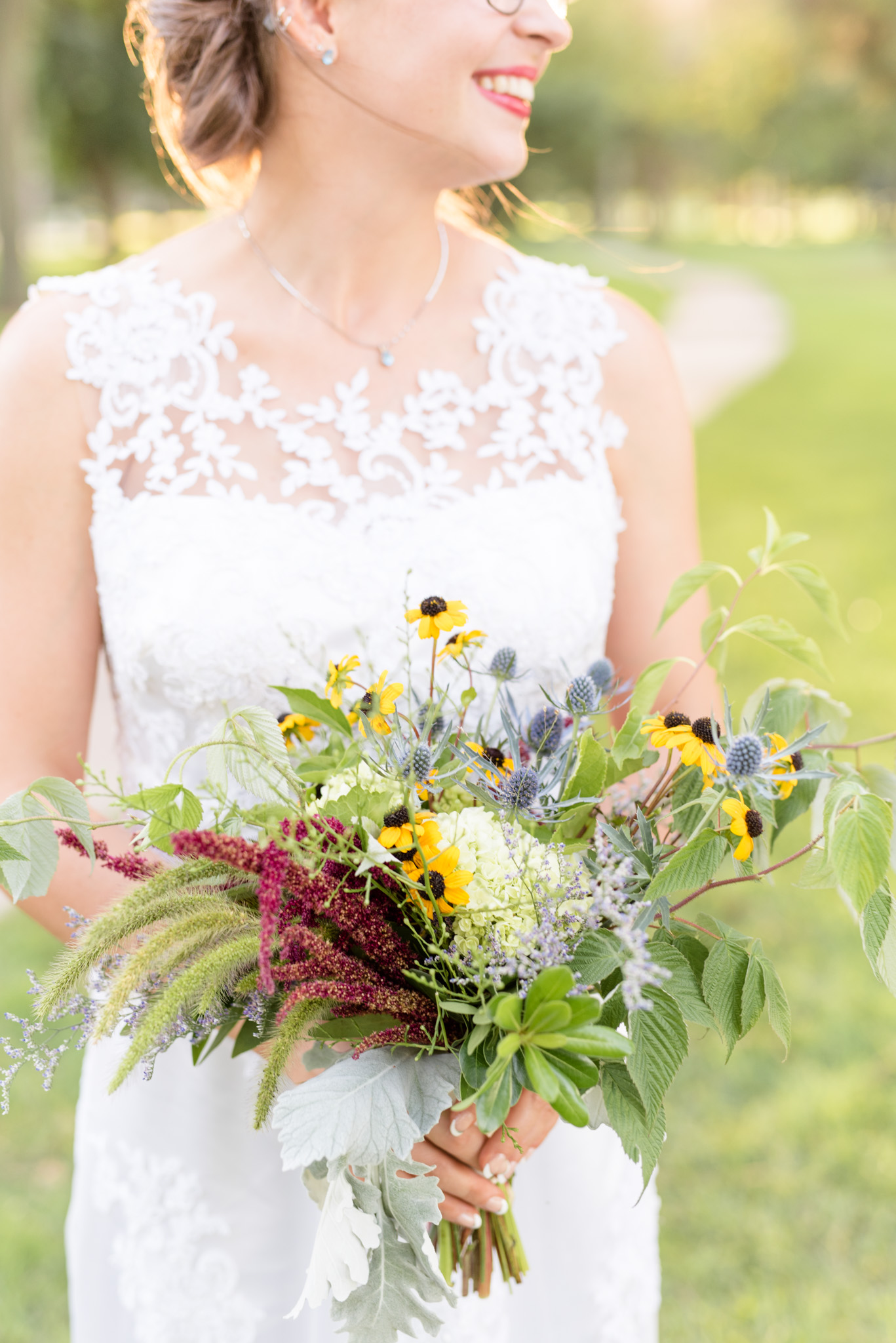 Bride holds bouquet.
