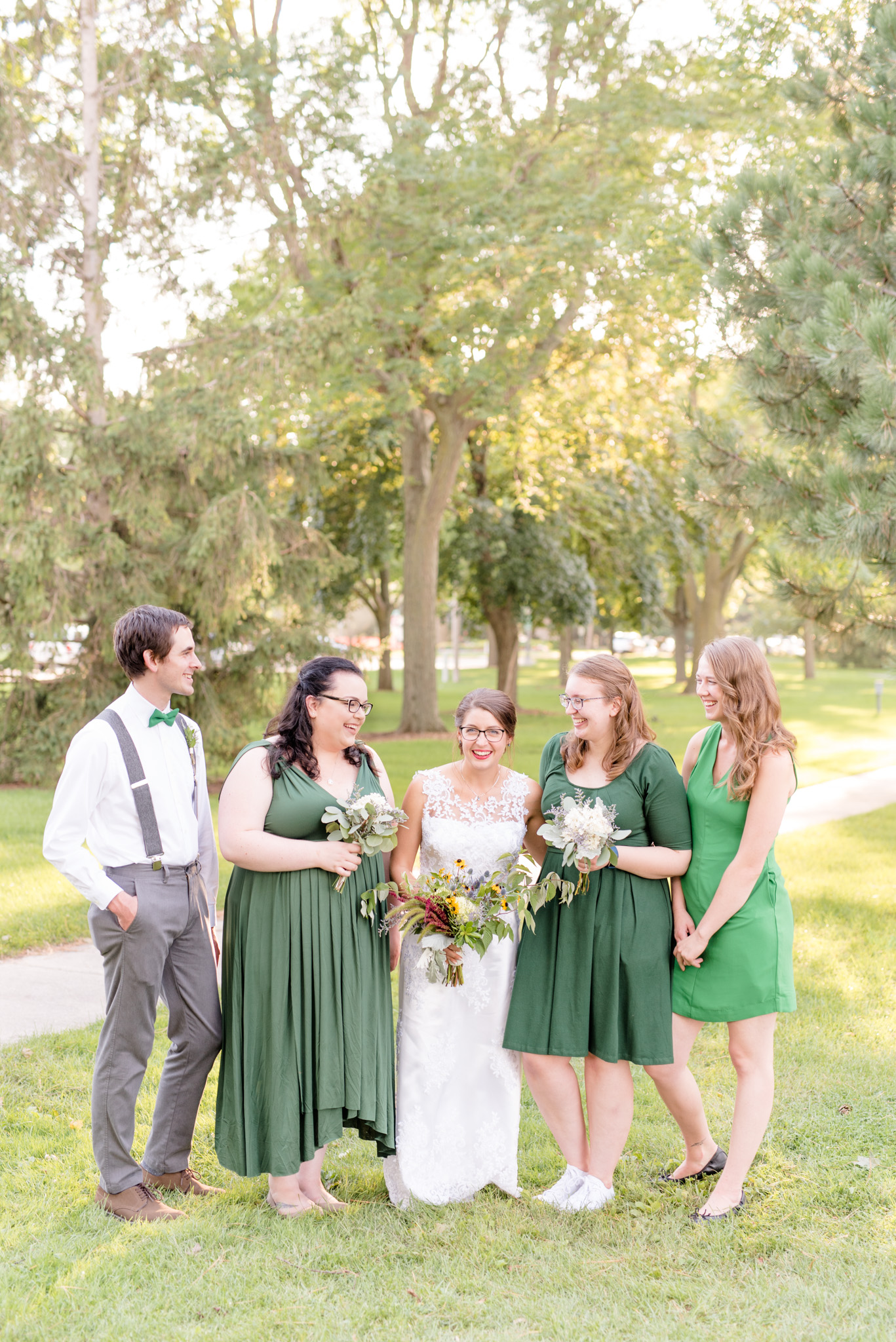 Bride and bridesmaids laugh together.