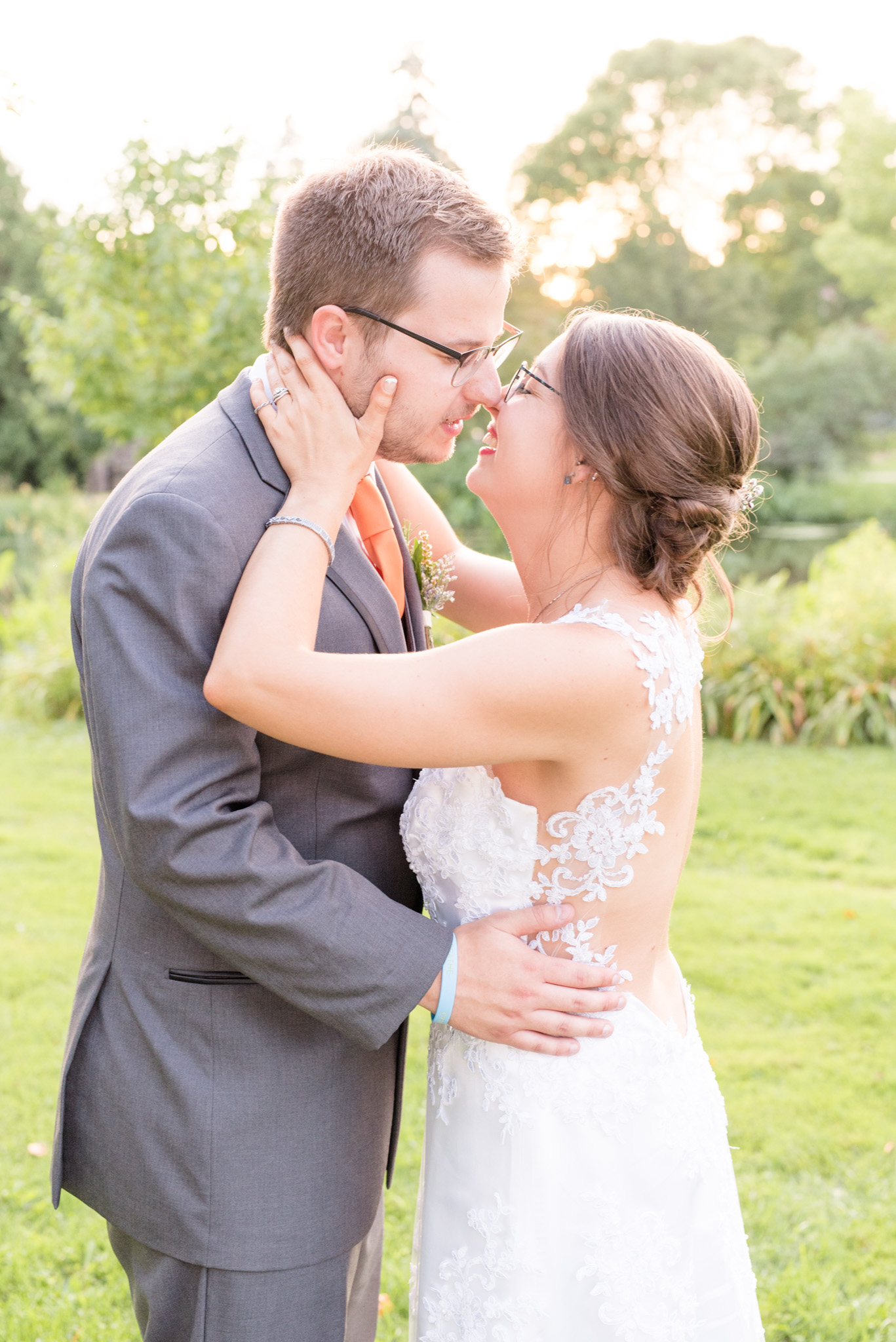 Bride and groom go in for kiss.