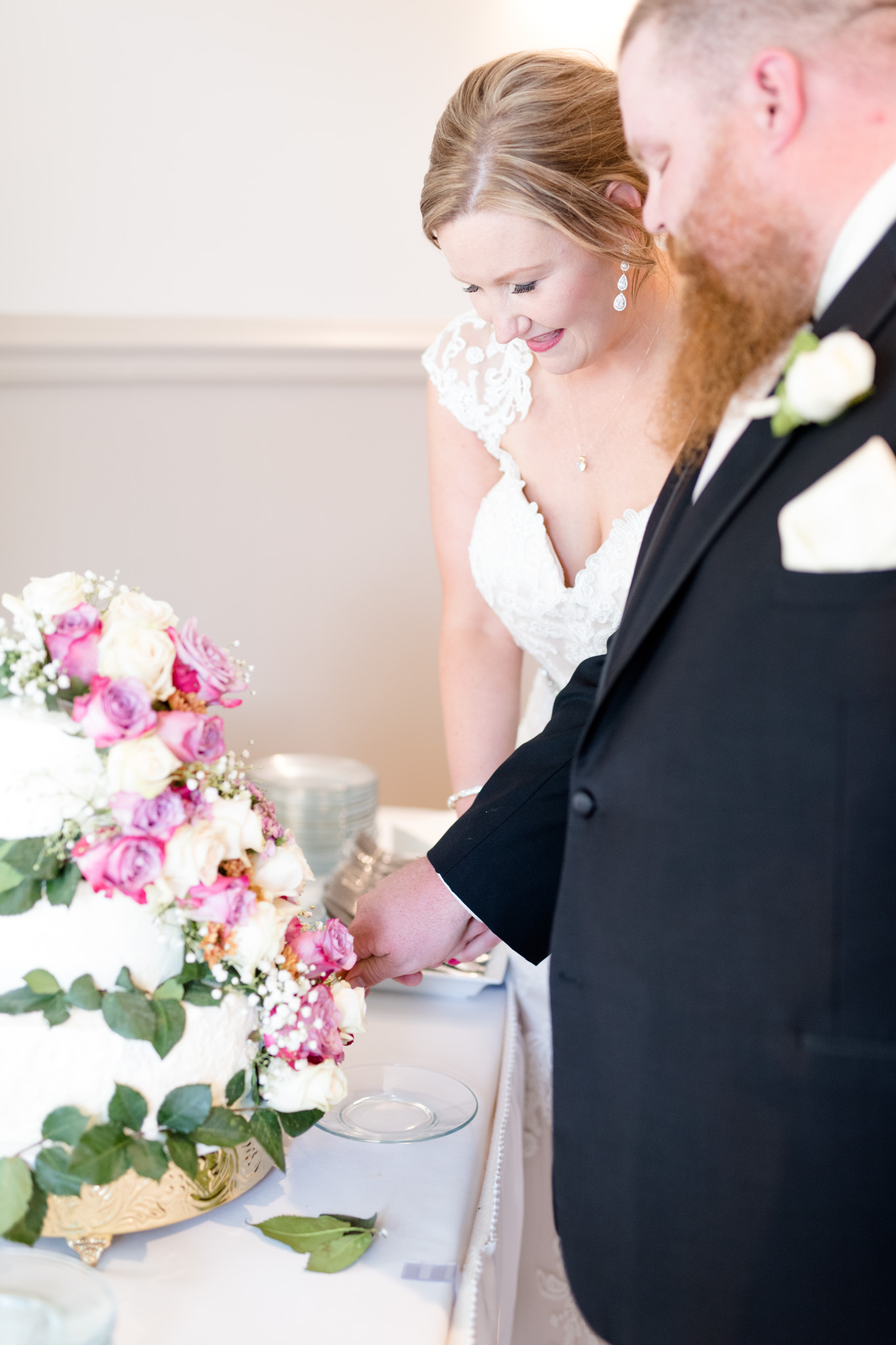 Bride and groom cut cake.