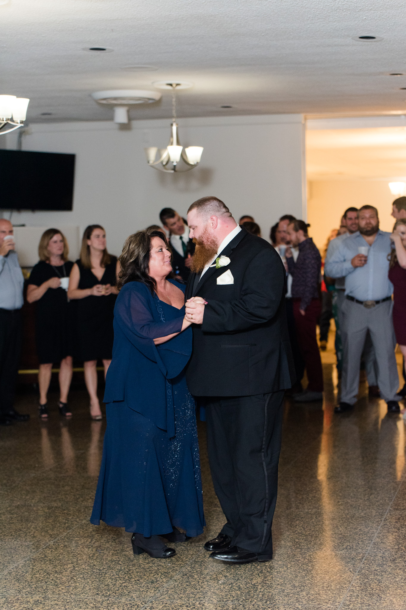 Groom and mother dance during wedding reception.