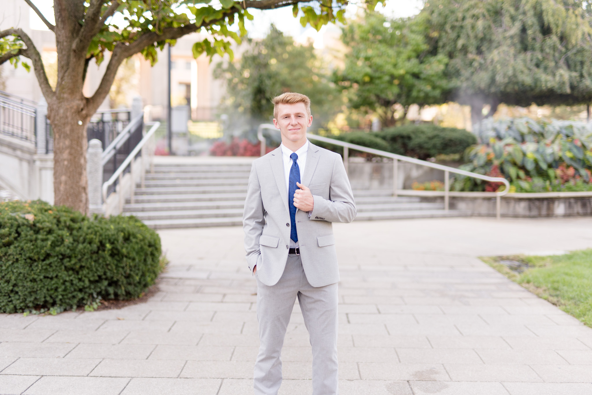 Senior guy looks at camera in urban downtown.