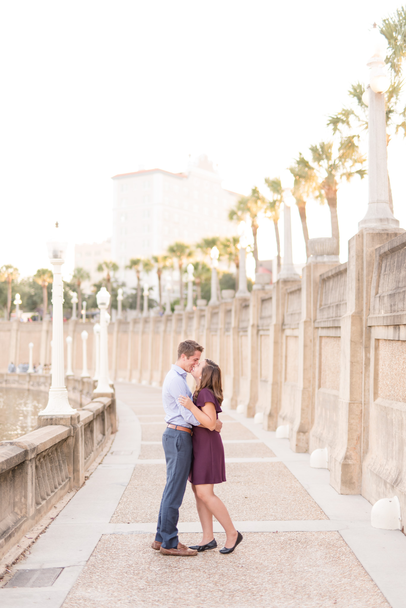 Couple kisses while standing on path.