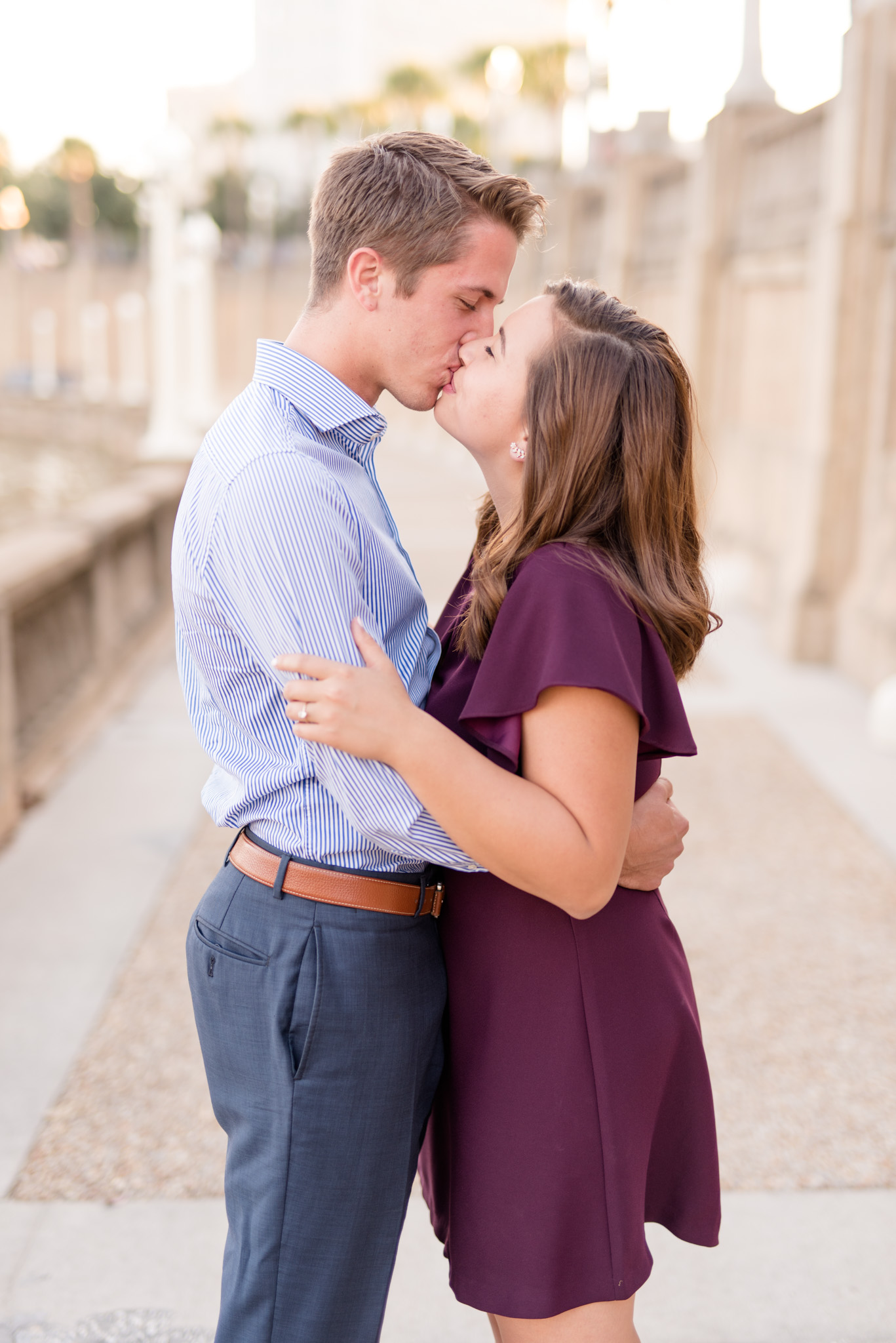 Couple kisses at sunset.