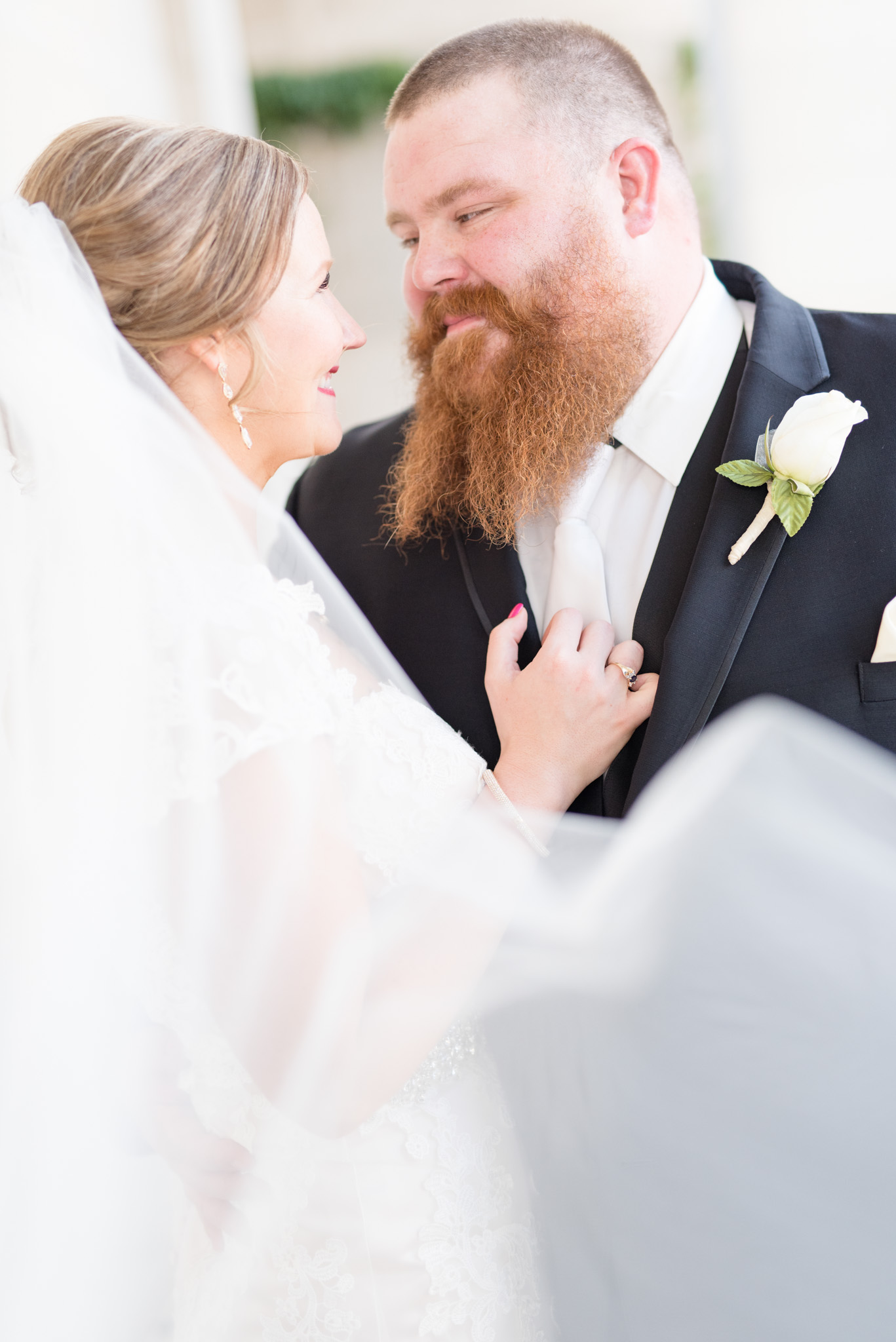 Groom looks lovingly at bride.