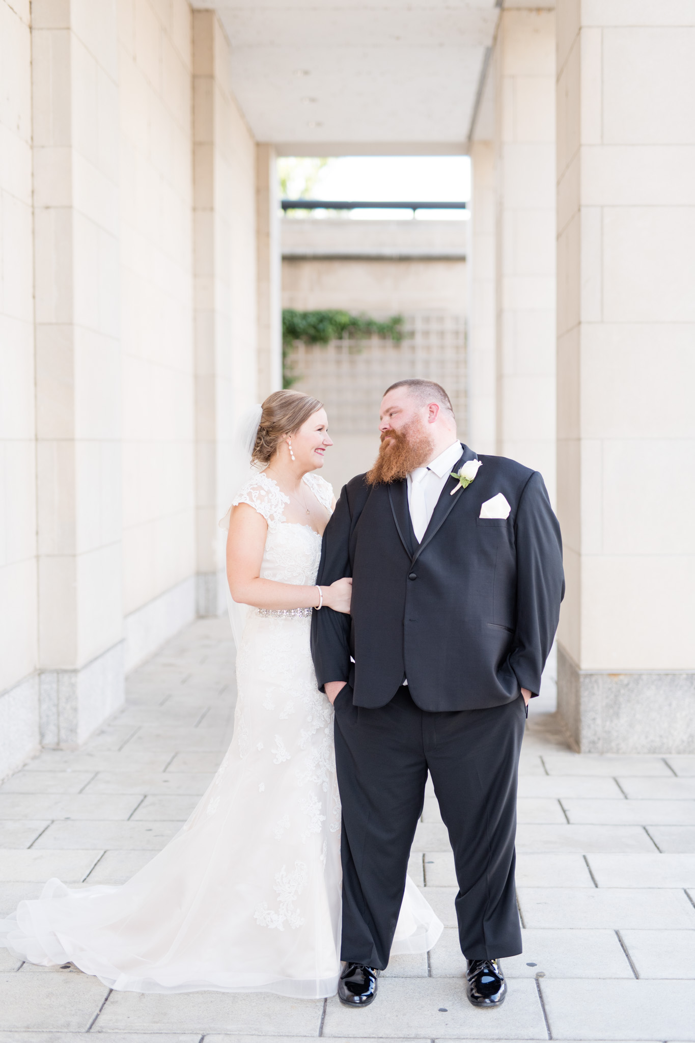 Bride and groom smile at each other.