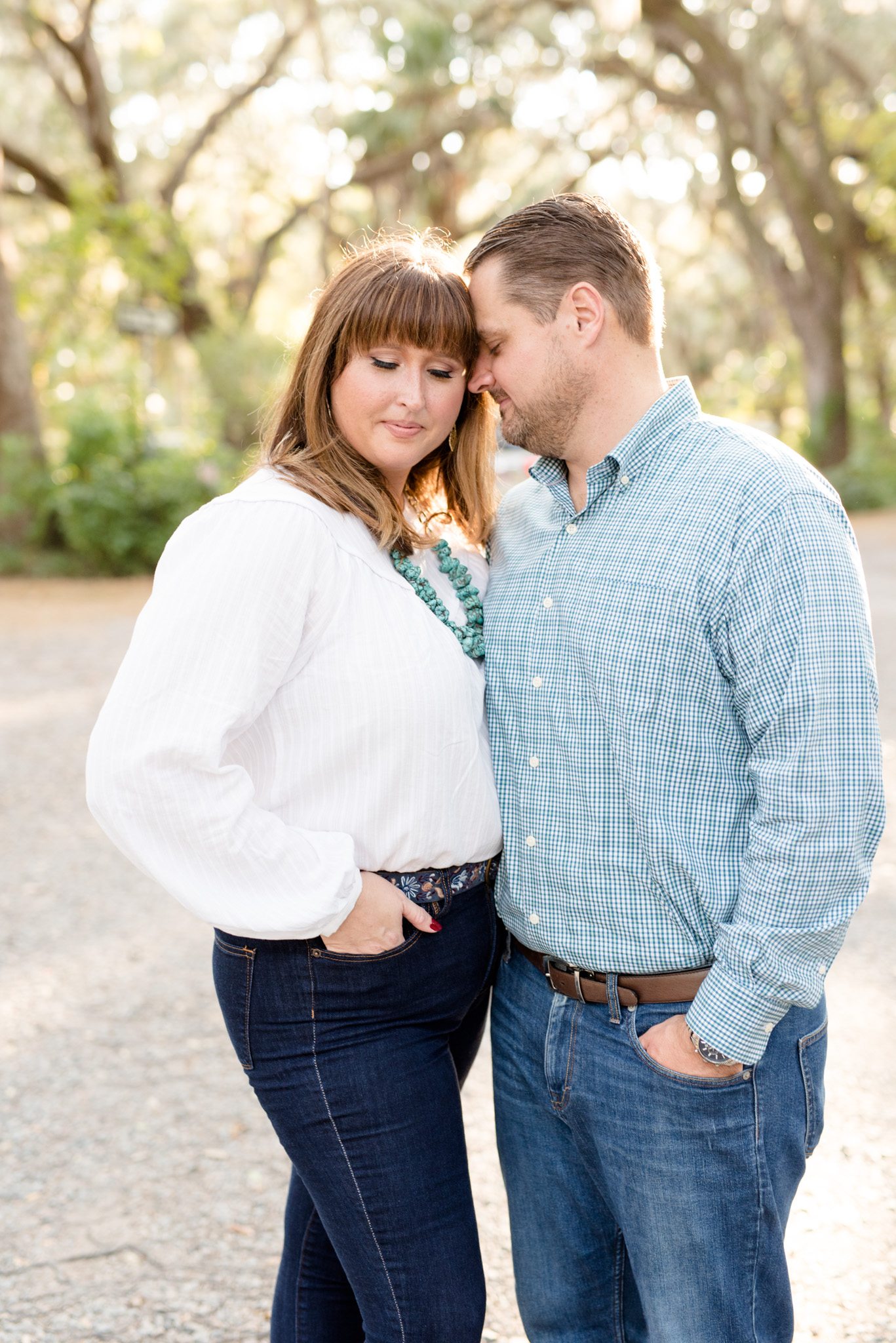 Engaged Couple cuddles in woodland.