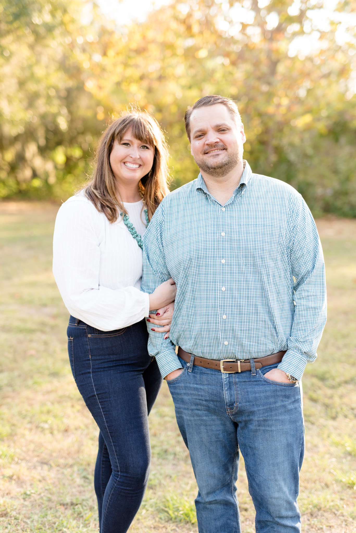 Couple smiles at sunset in Phillippe Park.