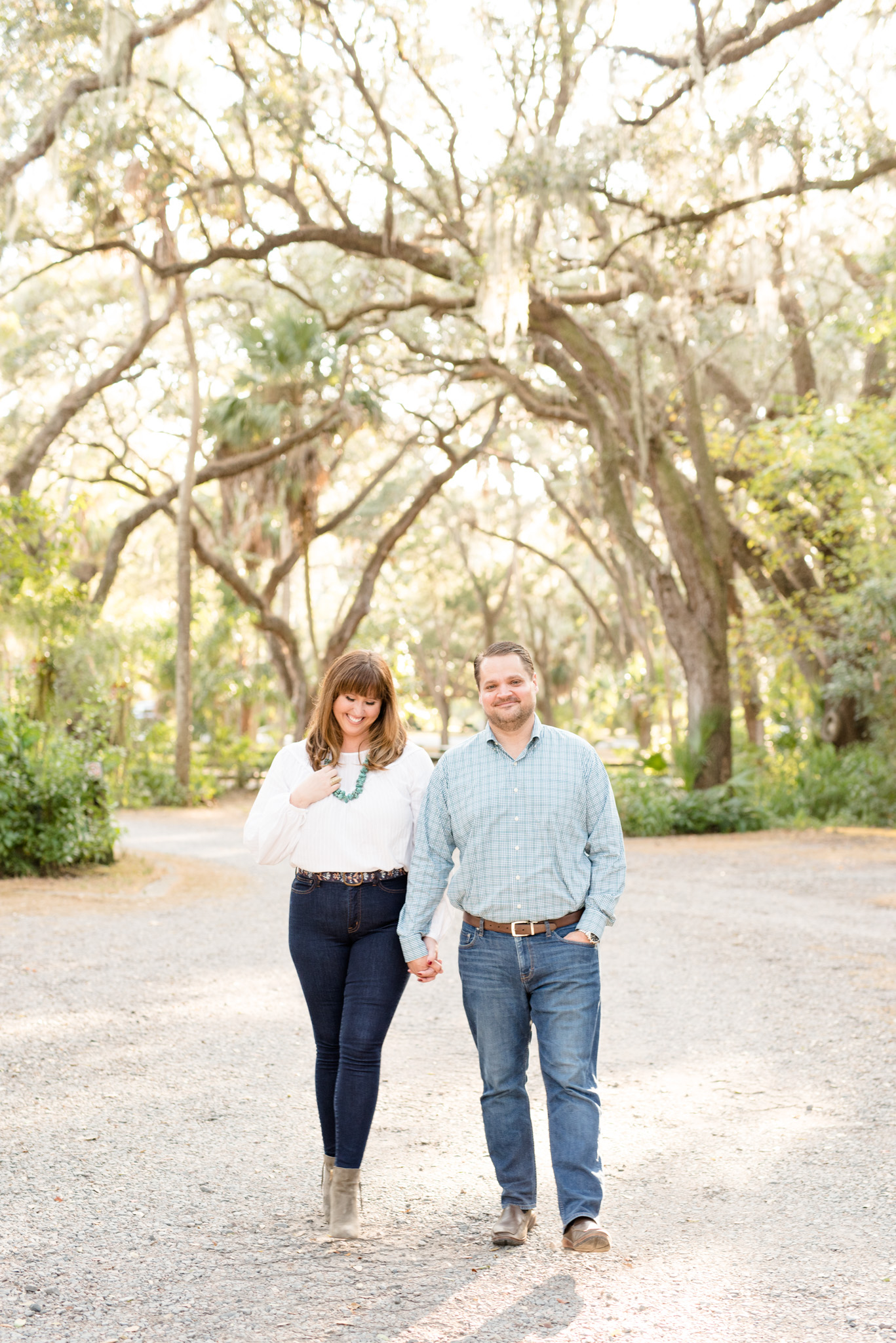 Couple walks through park.