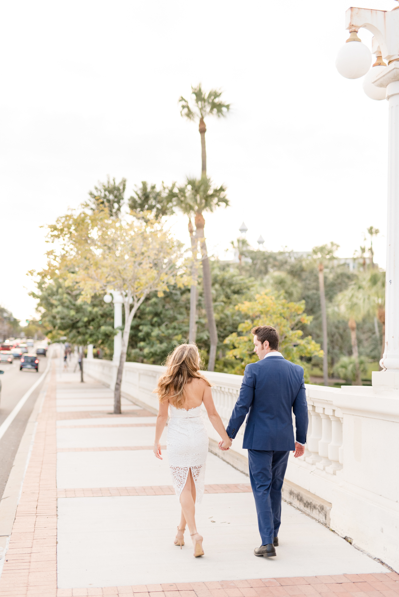 Couple walks together along bridge path.