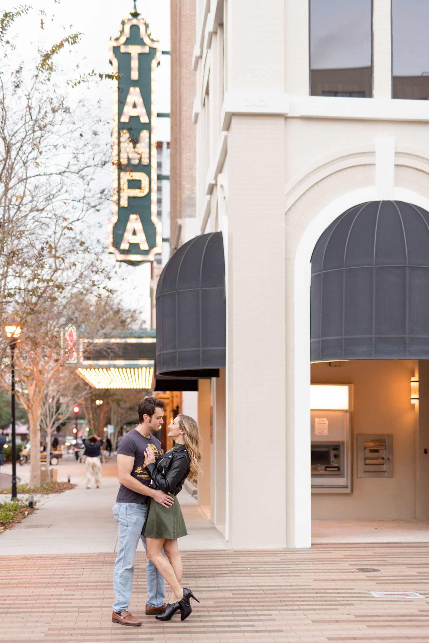 Couple poses in front of Tampa theater.