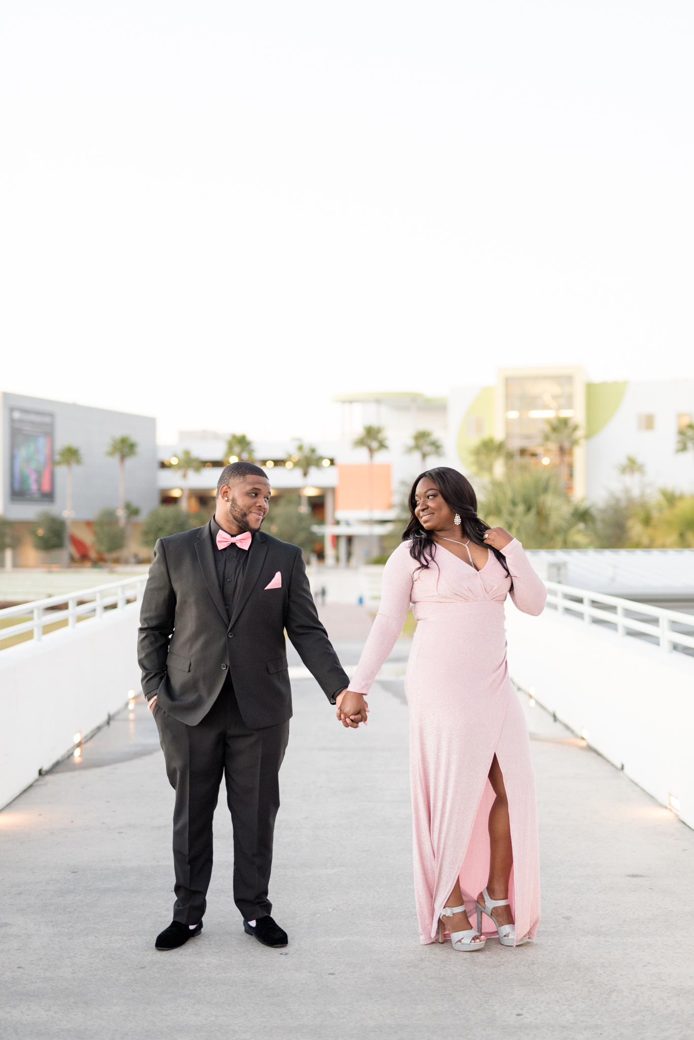 Couple smiles at each other during Tampa sunset.