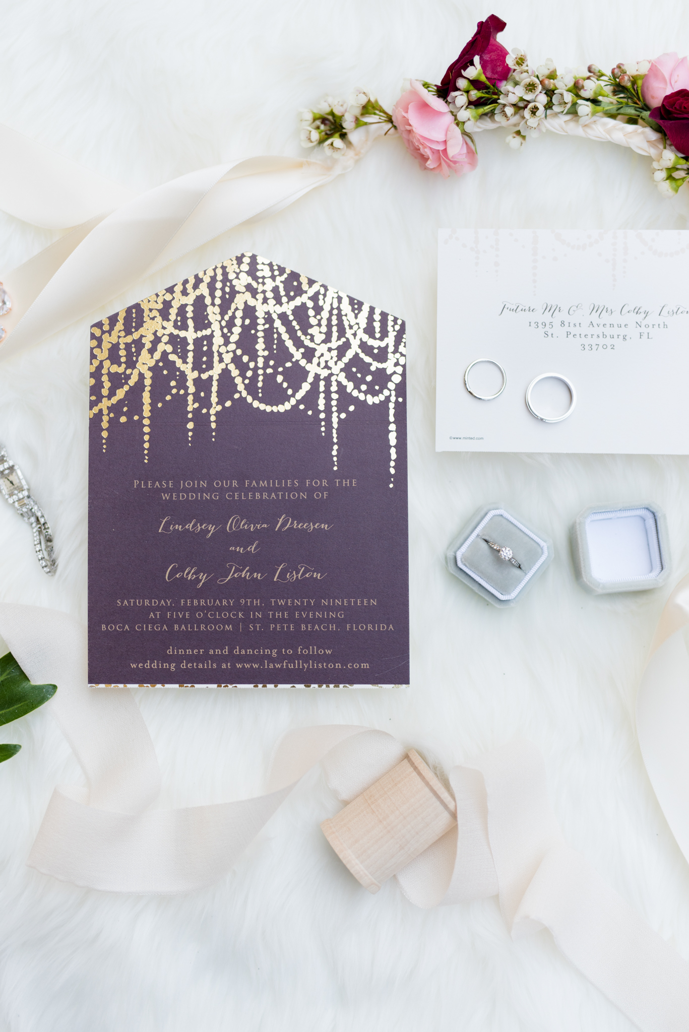 Wedding invitations sit with details.