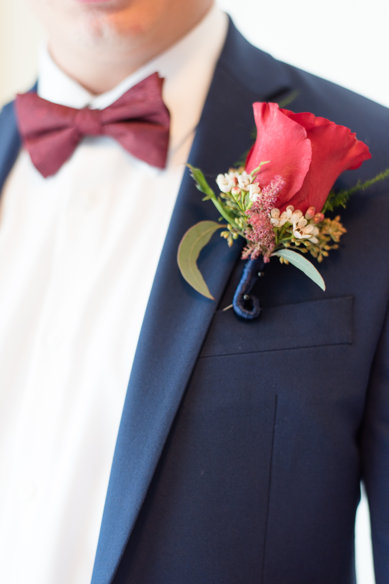 Groom's red rose boutonniere. 