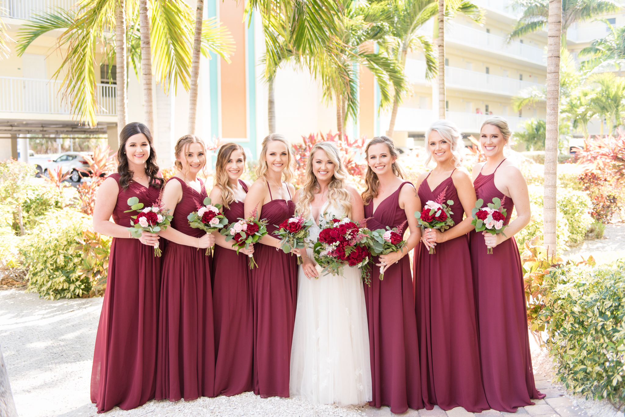 Bridal party smiles with in garden.