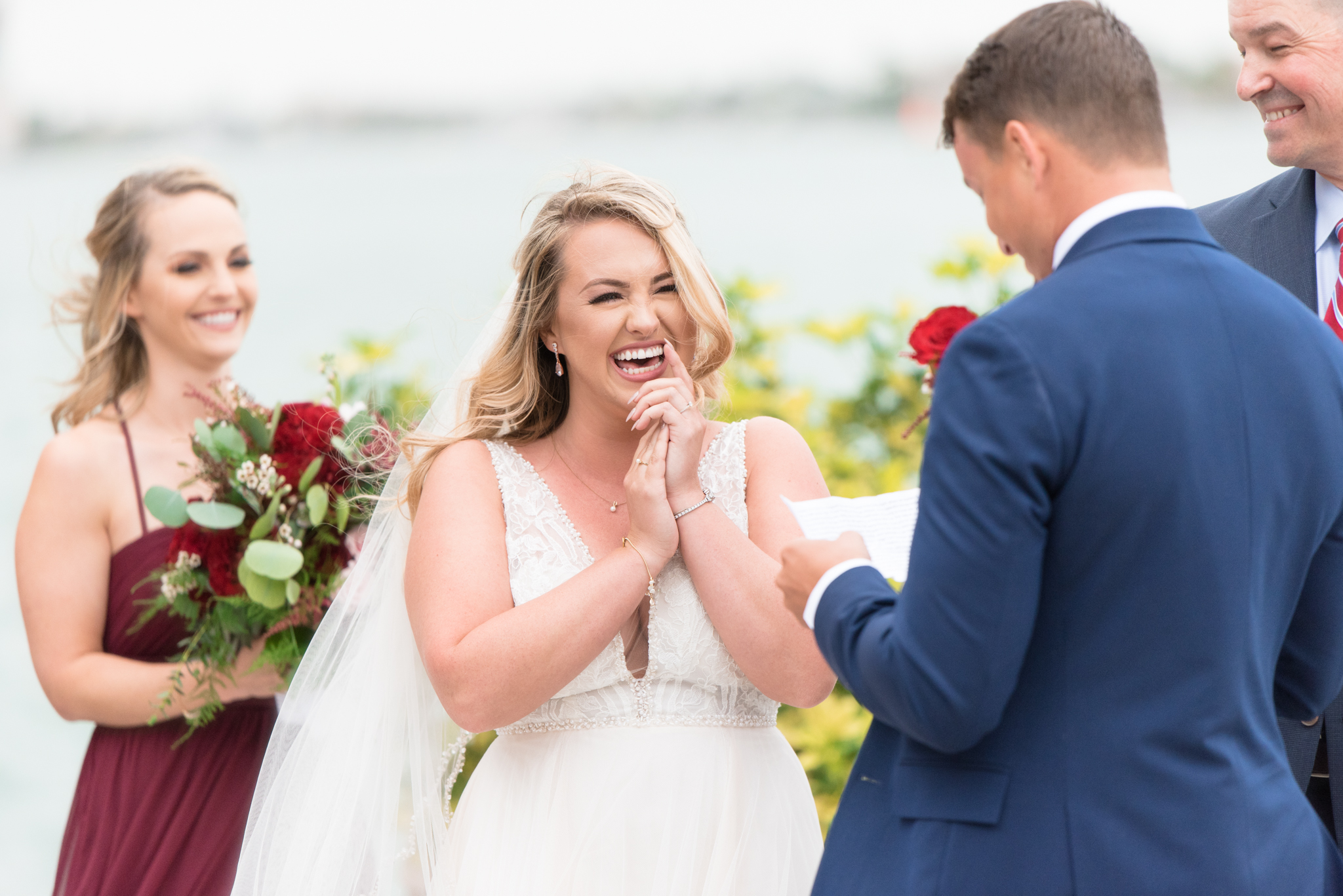 Bride laughs during wedding ceremony.