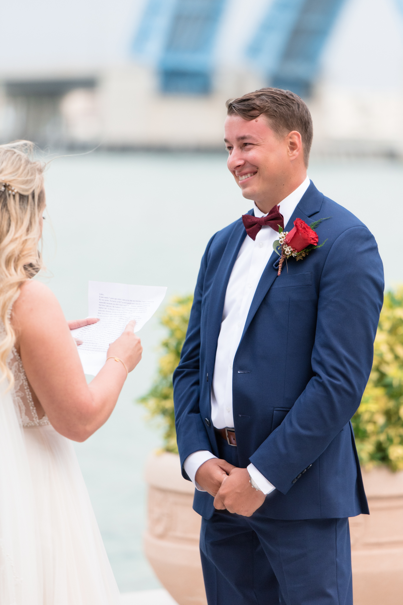 Groom laughs during wedding ceremony.