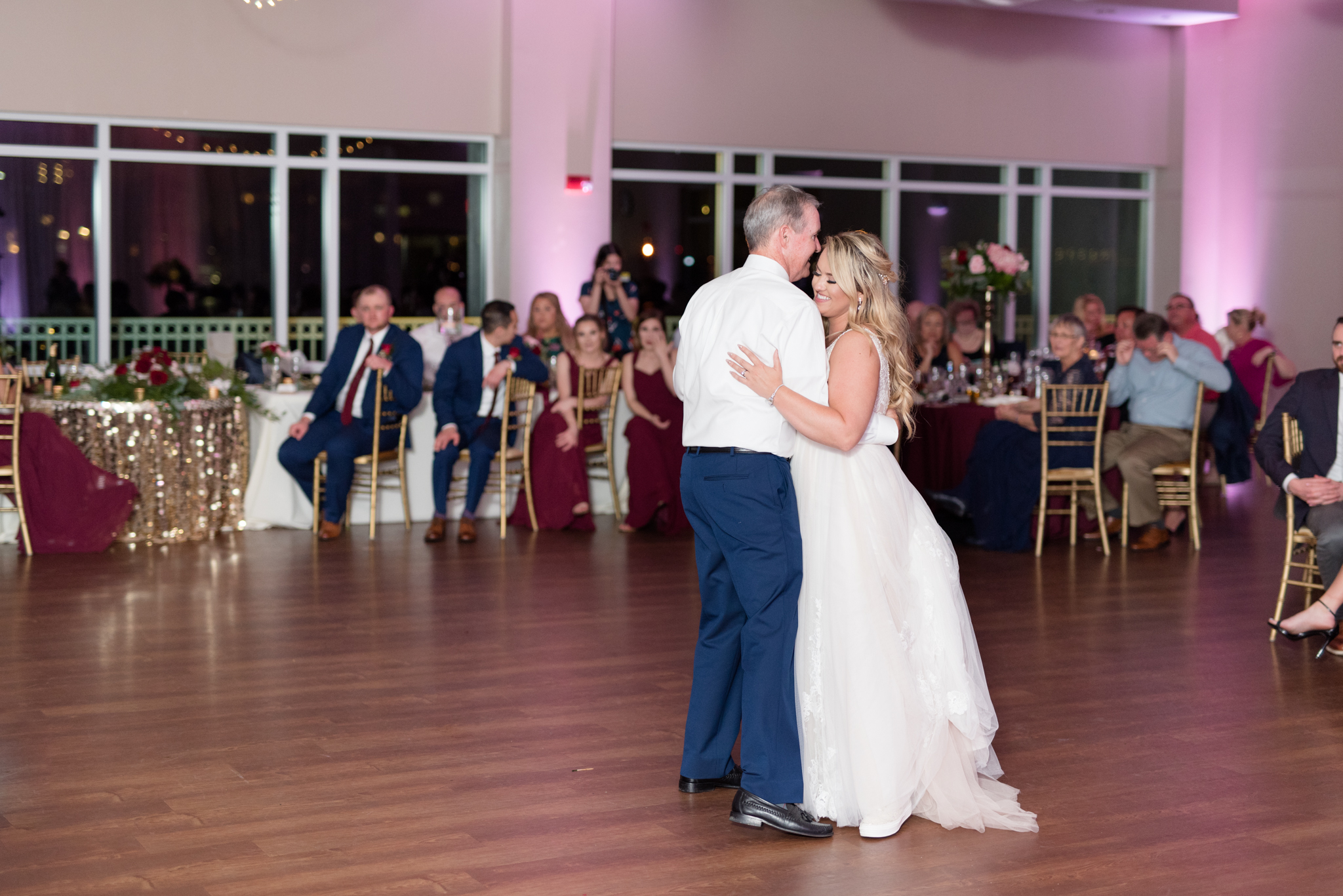 Bride and father dance together.