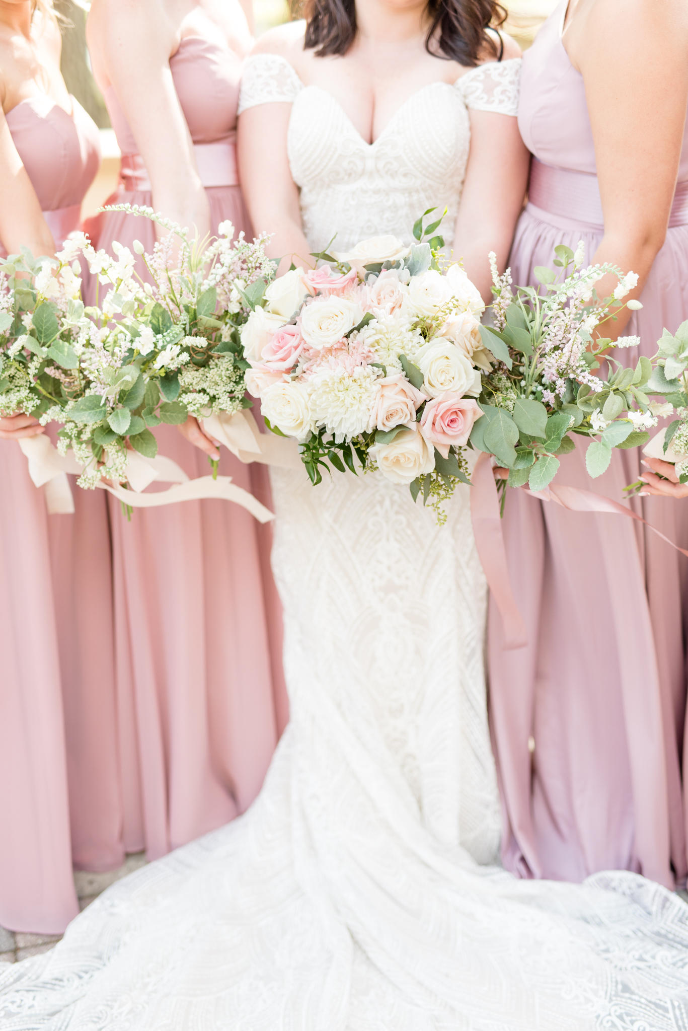 Bride and bridesmaids holding flowers.