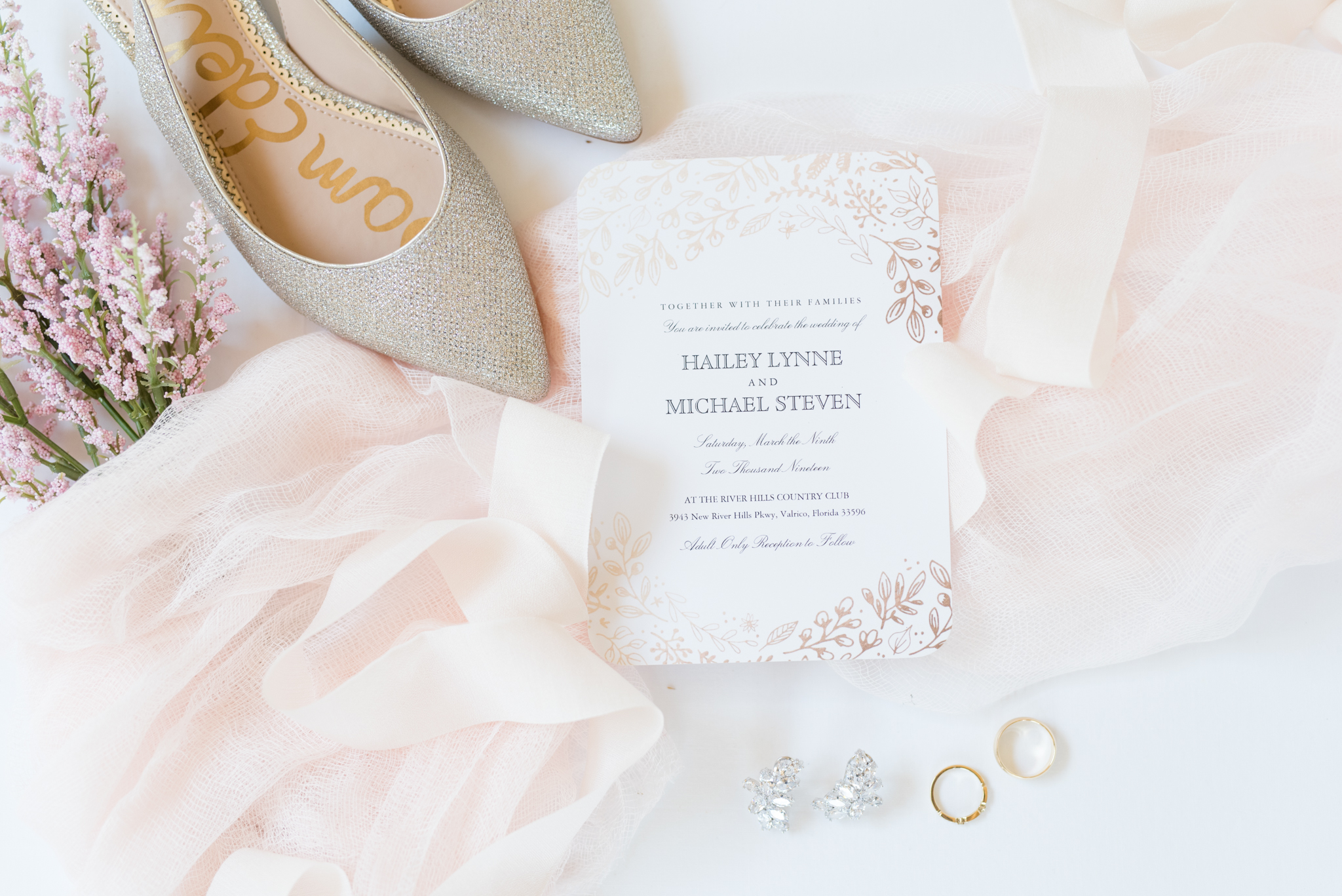 Wedding invitation, shoes, and ring.