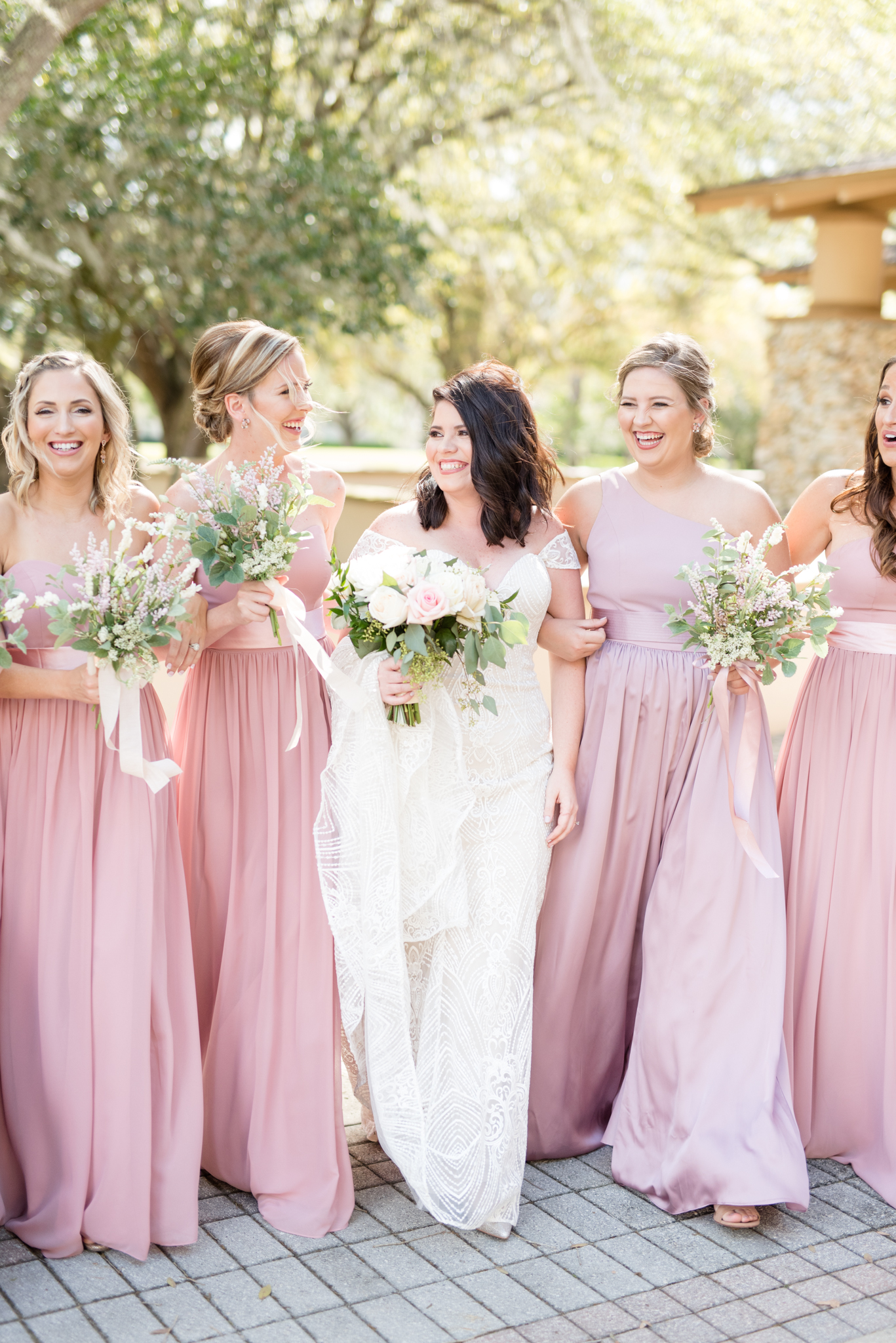 Bridal party walks and laughs.
