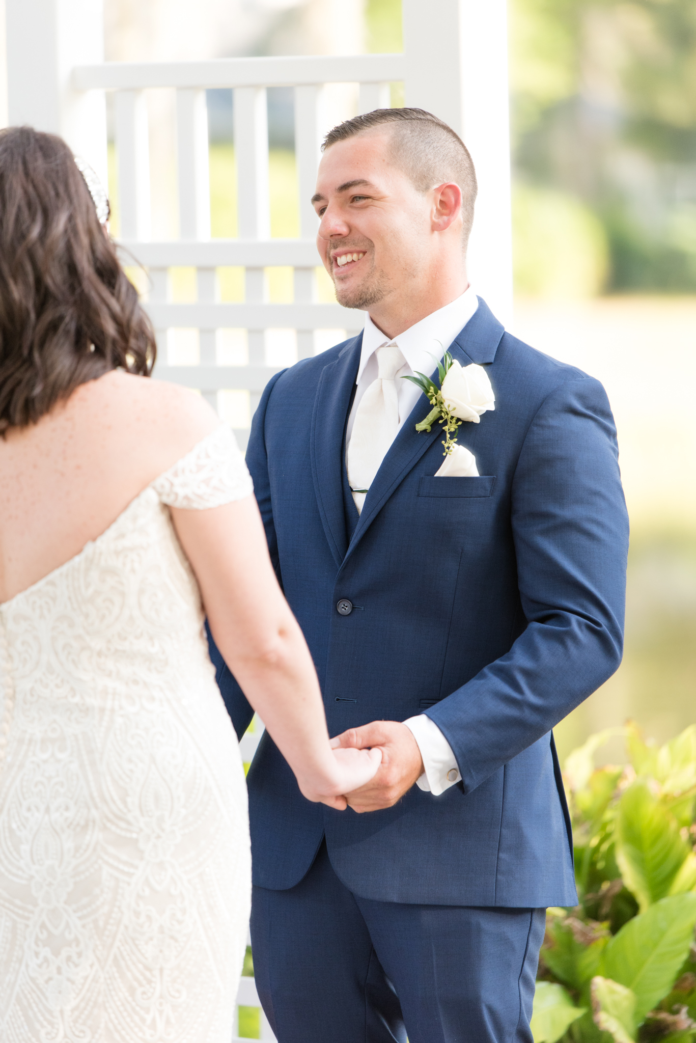 Groom smiles during ceremony.