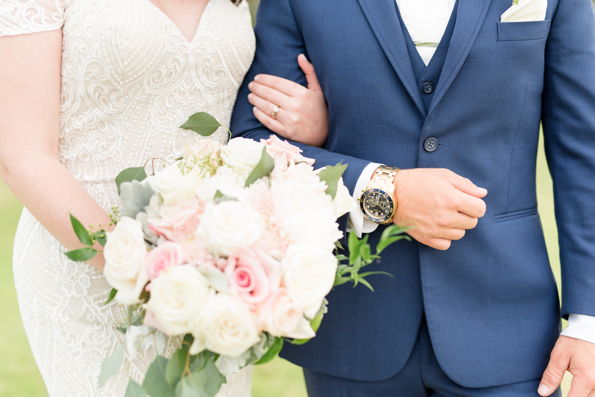 Grooms watch and bride's flowers.