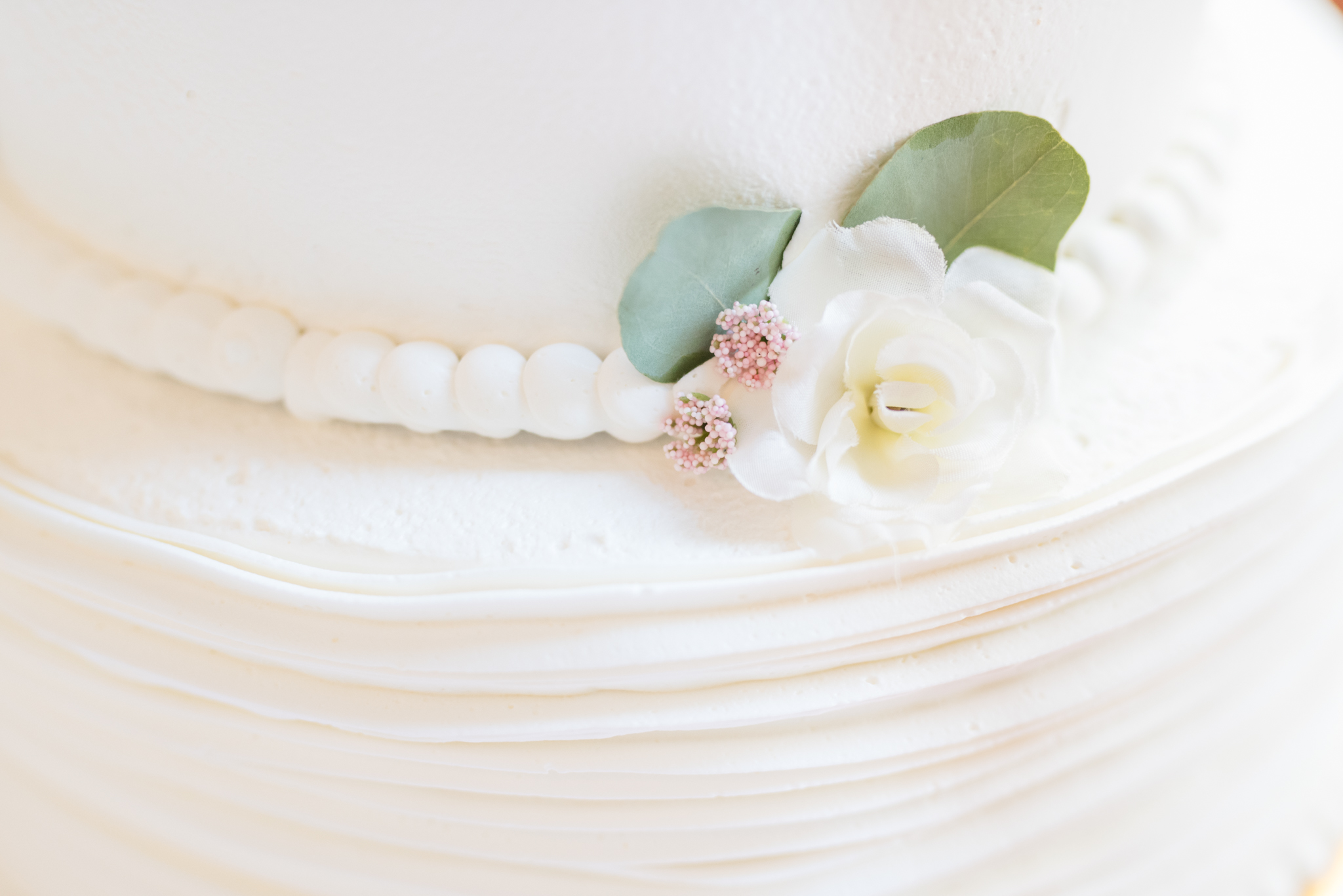 Closeup of flower on wedding cake.