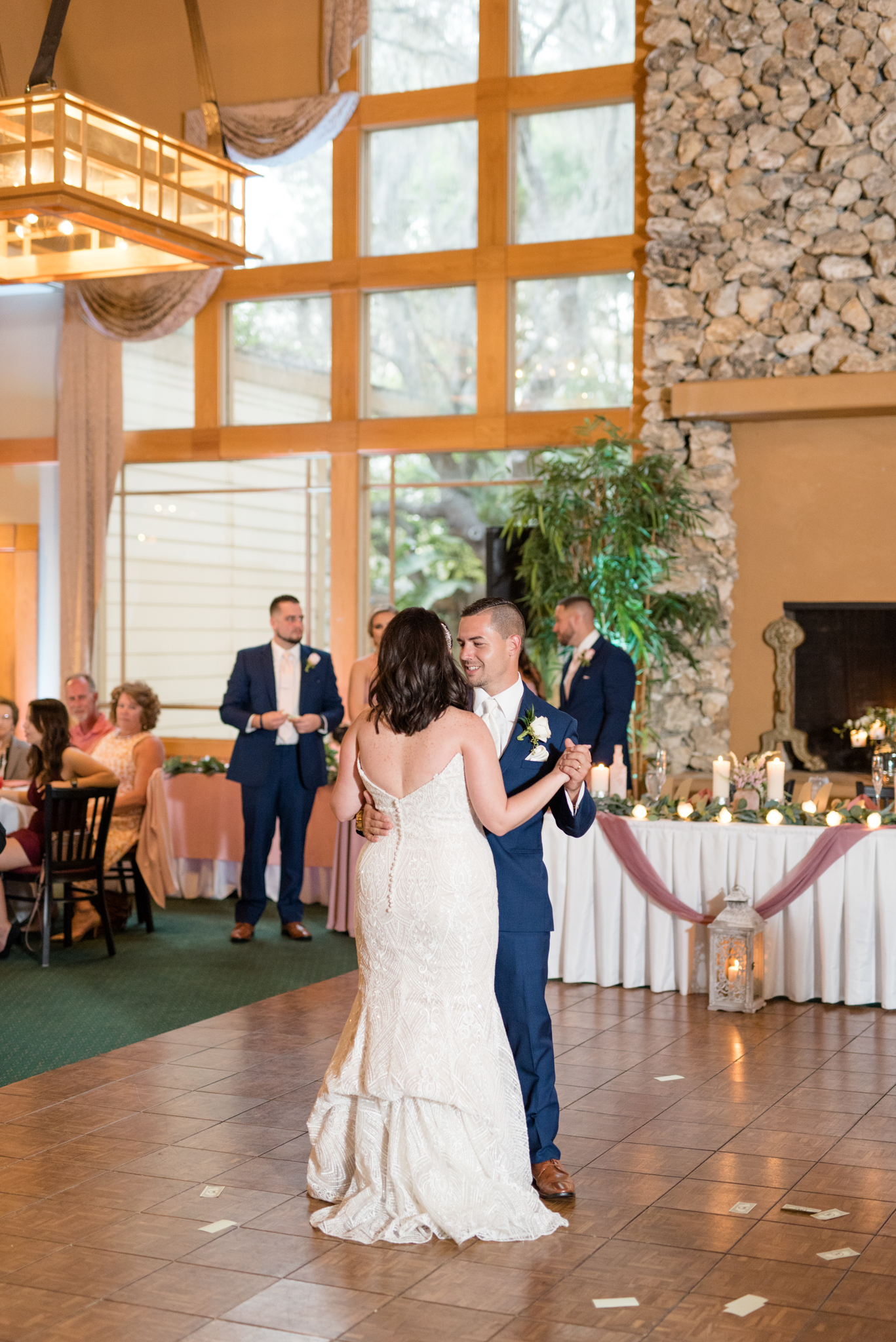 Bride and groom dance together.