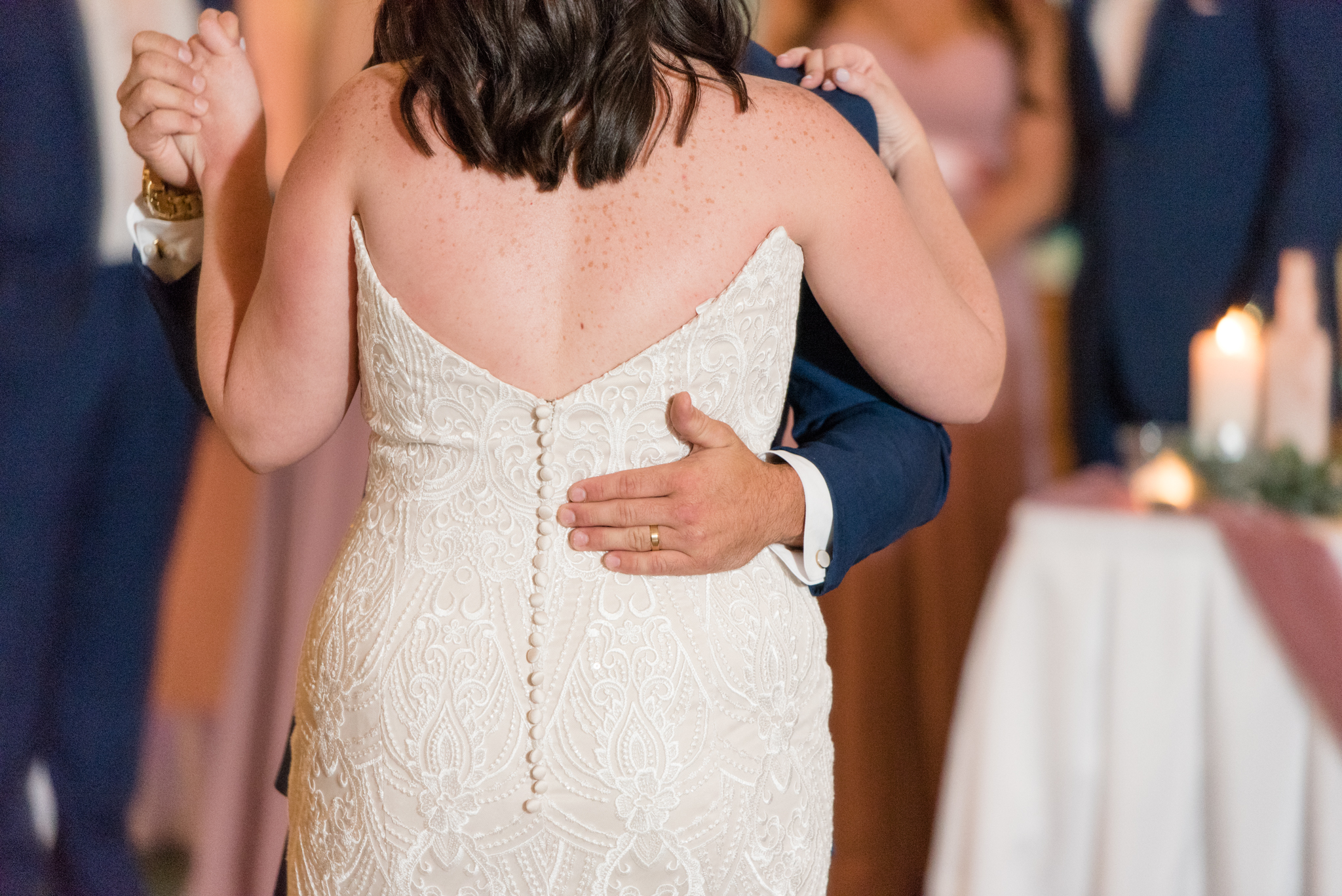 Groom holds bride during dance.