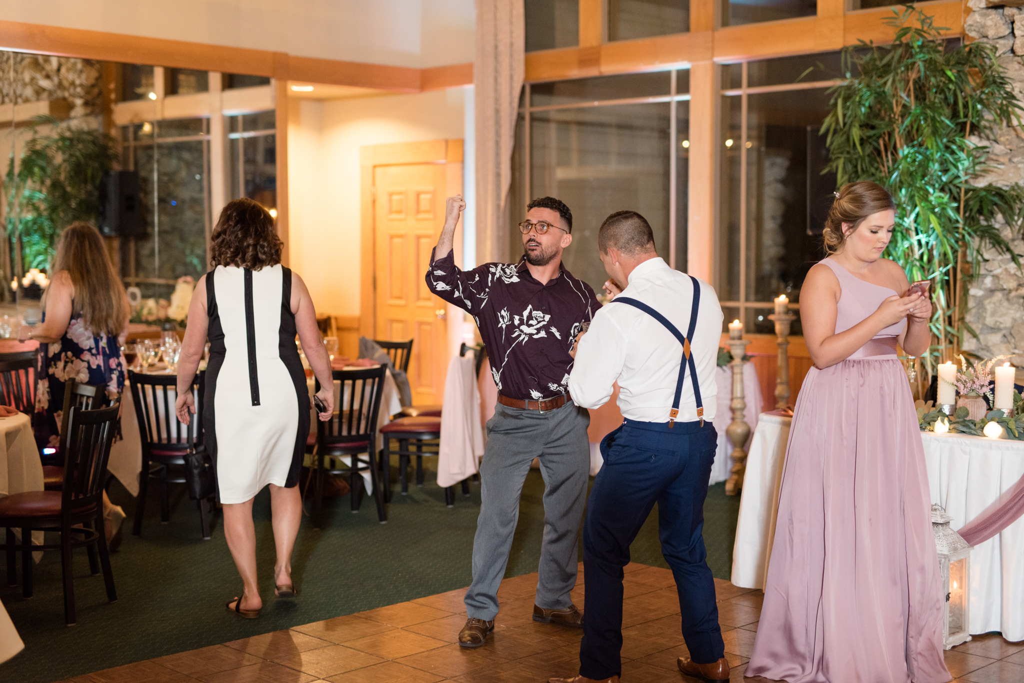 Wedding guests dance at reception.