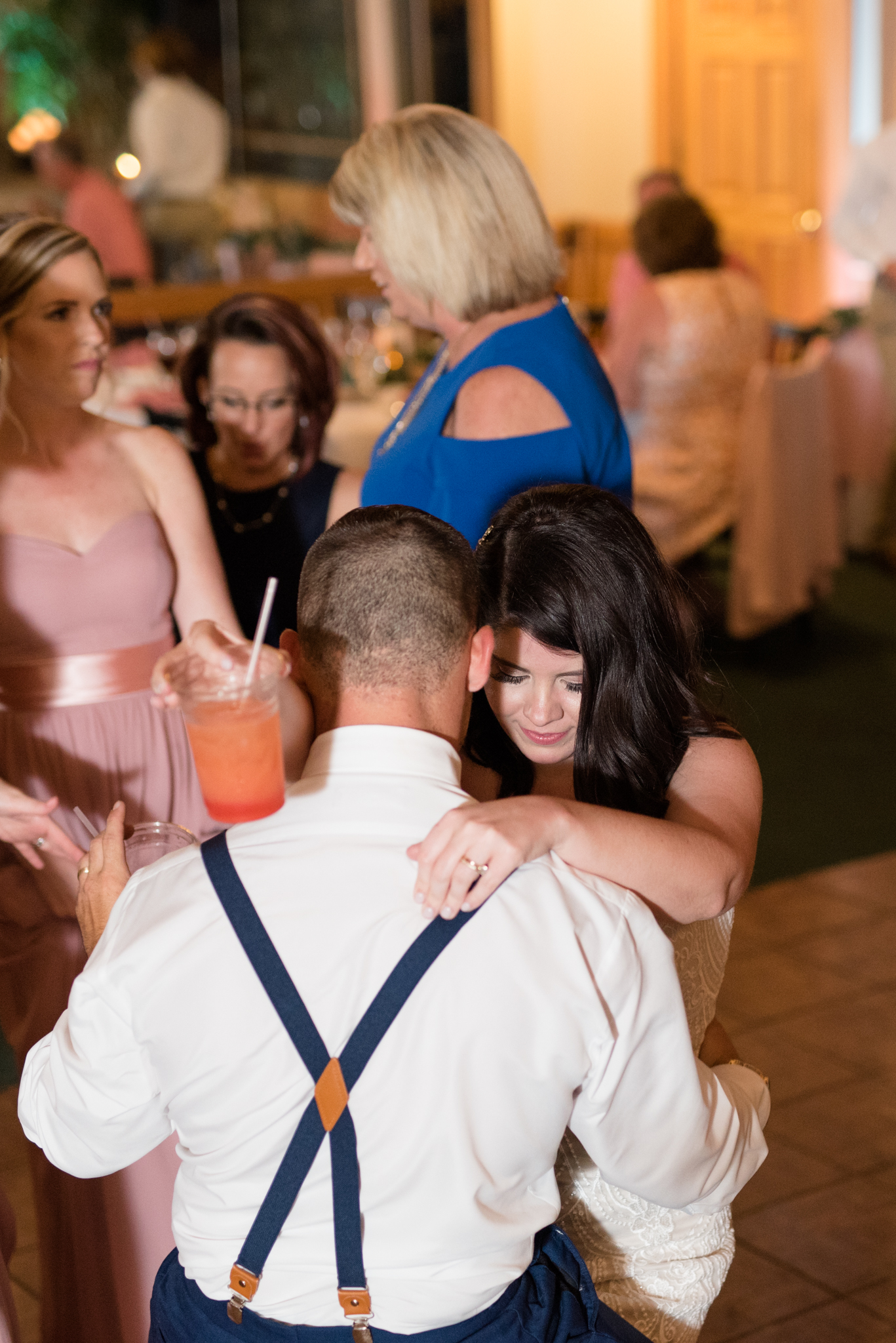 Bride and groom dance together.