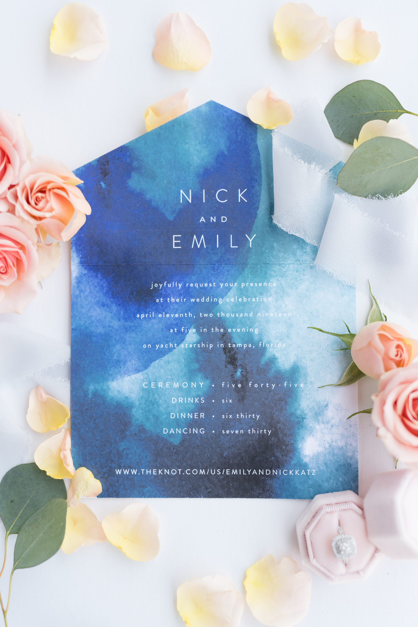Wedding Invitation sits with garden roses.