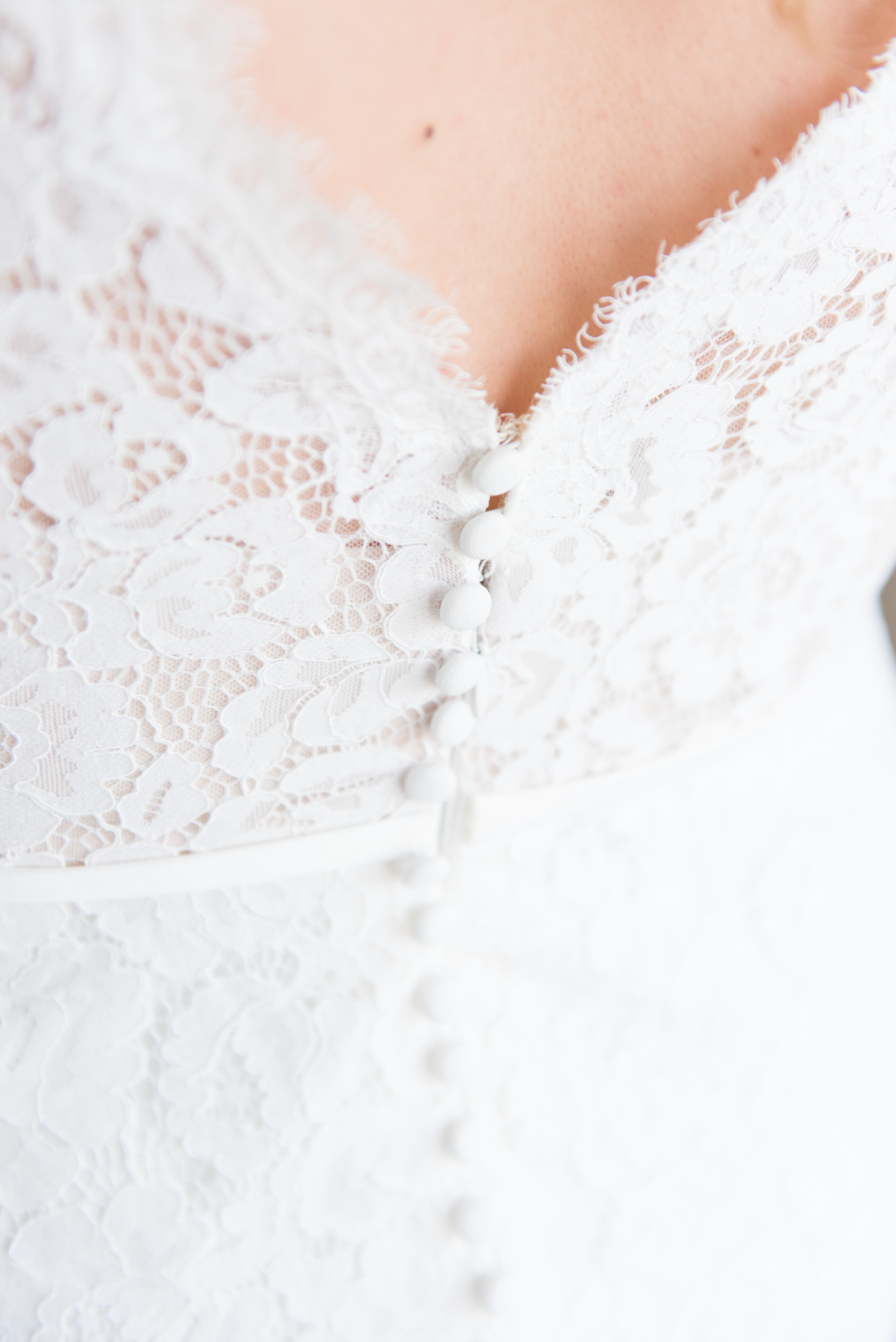 Lace details and buttons of wedding gown.