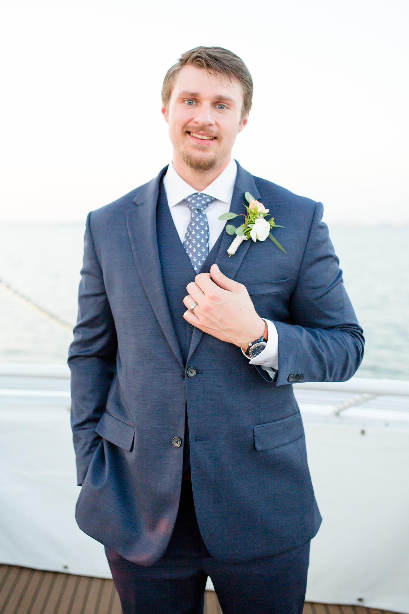 Groom smiles at camera.