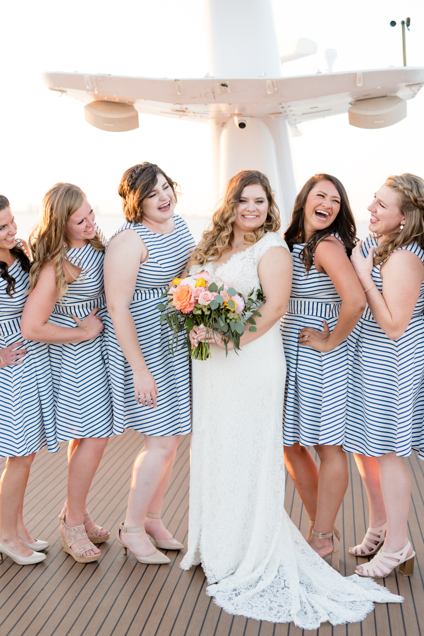 Bride and bridesmaids have fun on yacht.