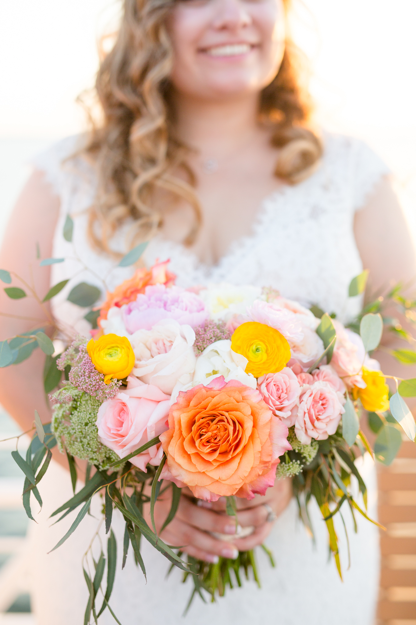 Bride holds wedding florals.
