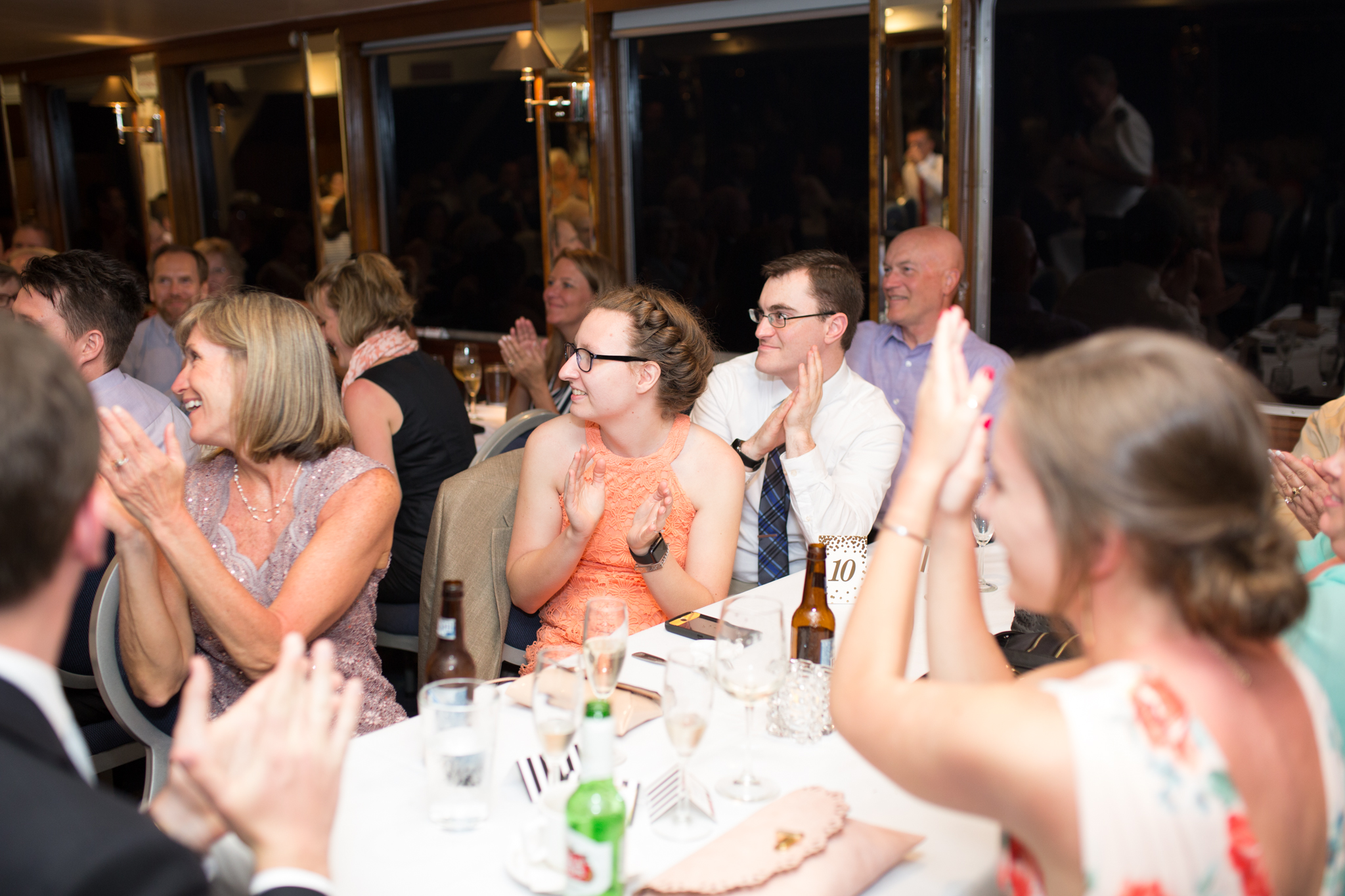 Wedding guests clap.