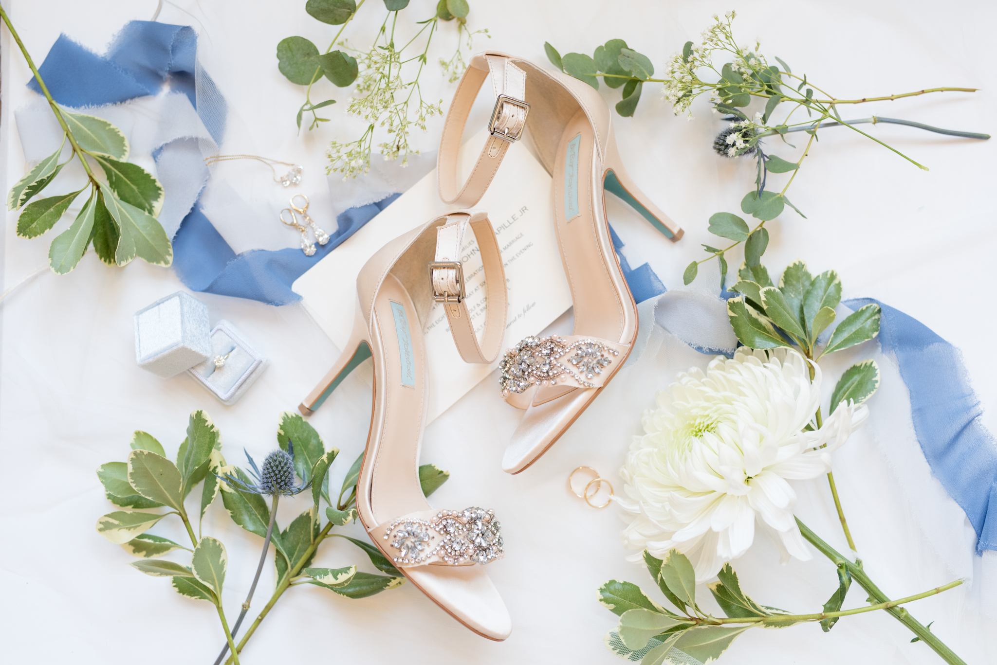 Bridal shoes sit with wedding details.