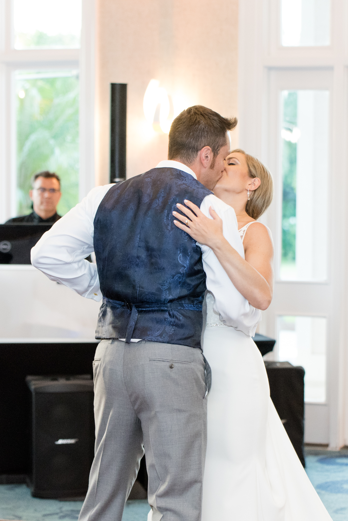 Bride and groom kiss during first kiss.