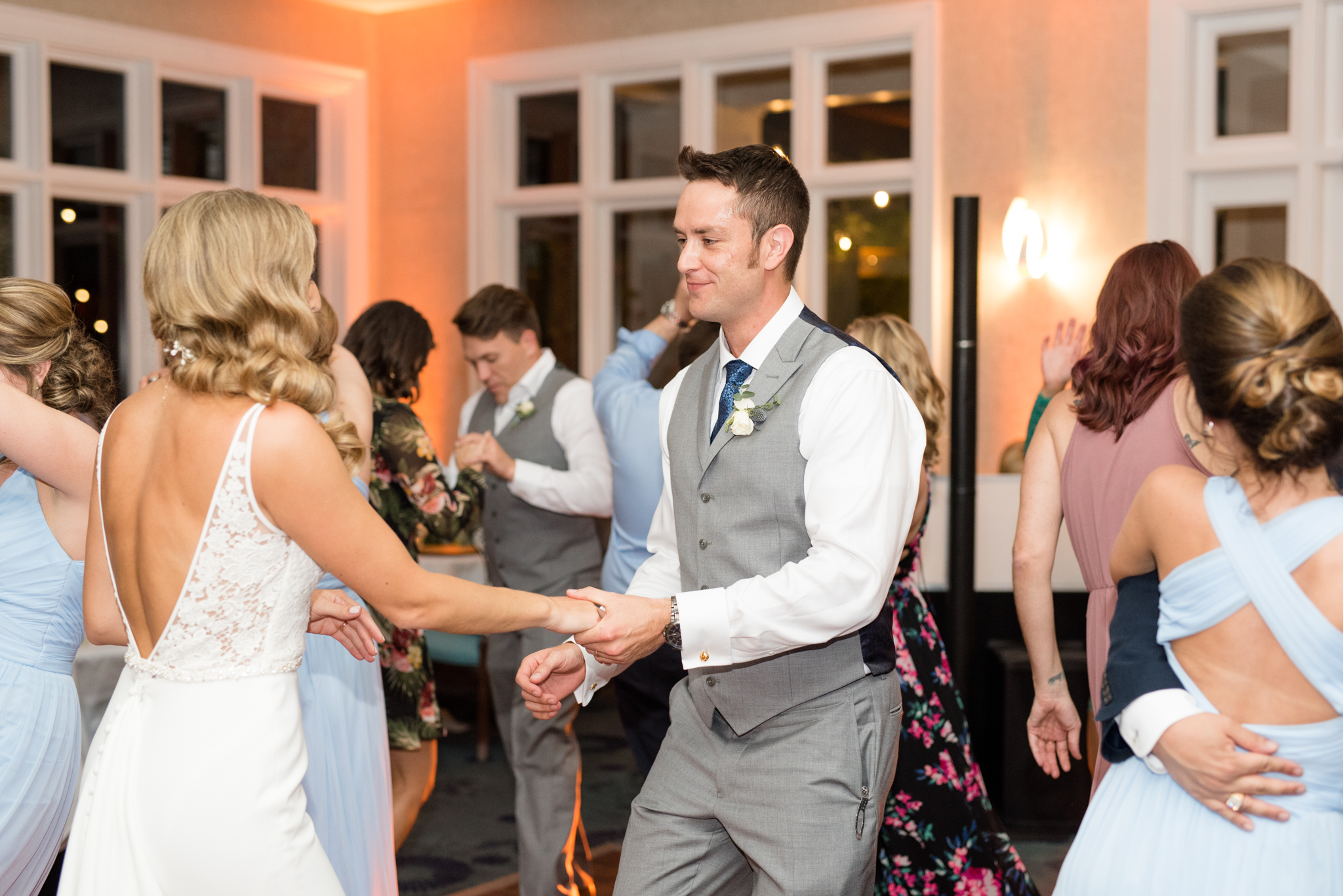 Bride and groom dance together at reception.