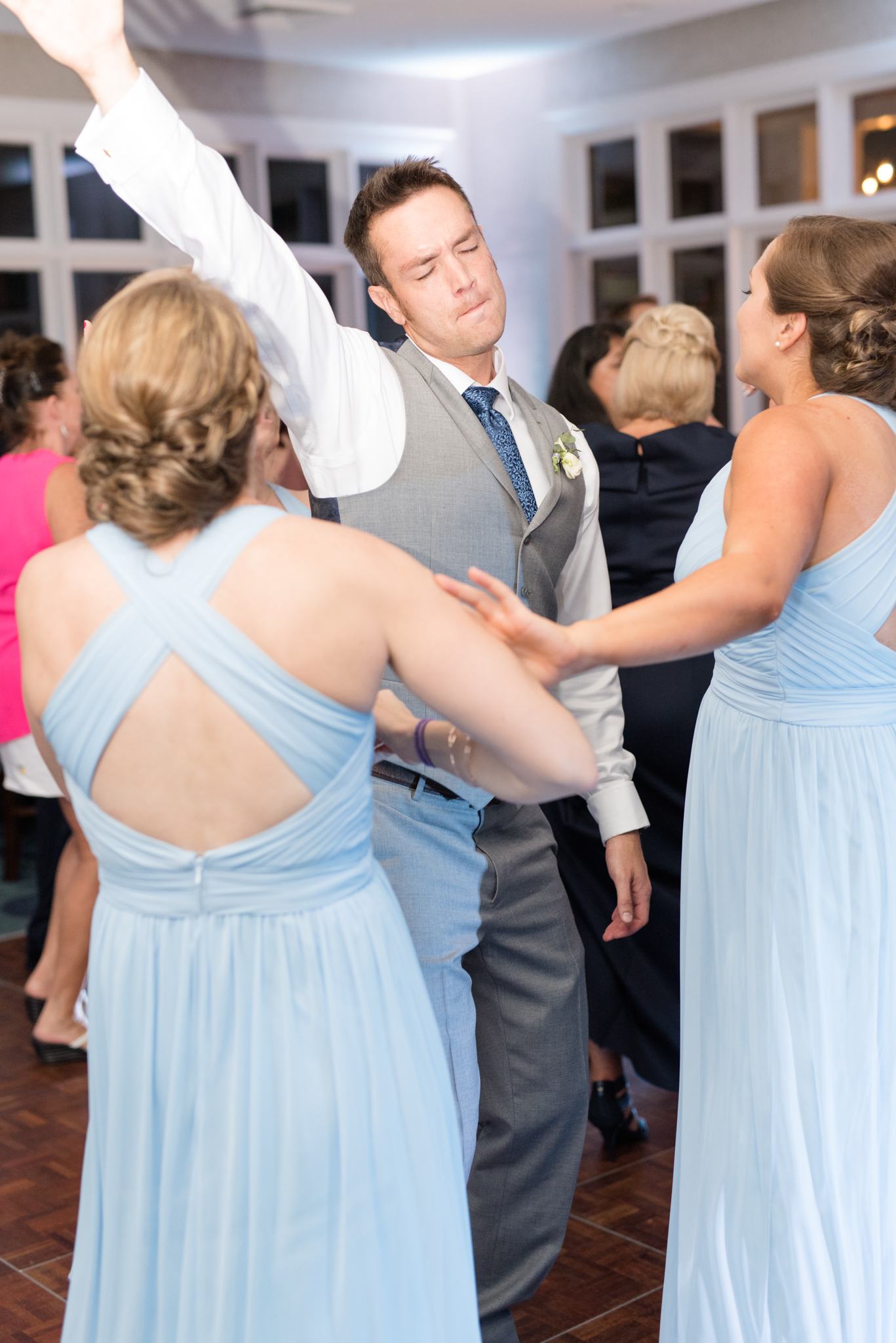 Groom dances at wedding reception.