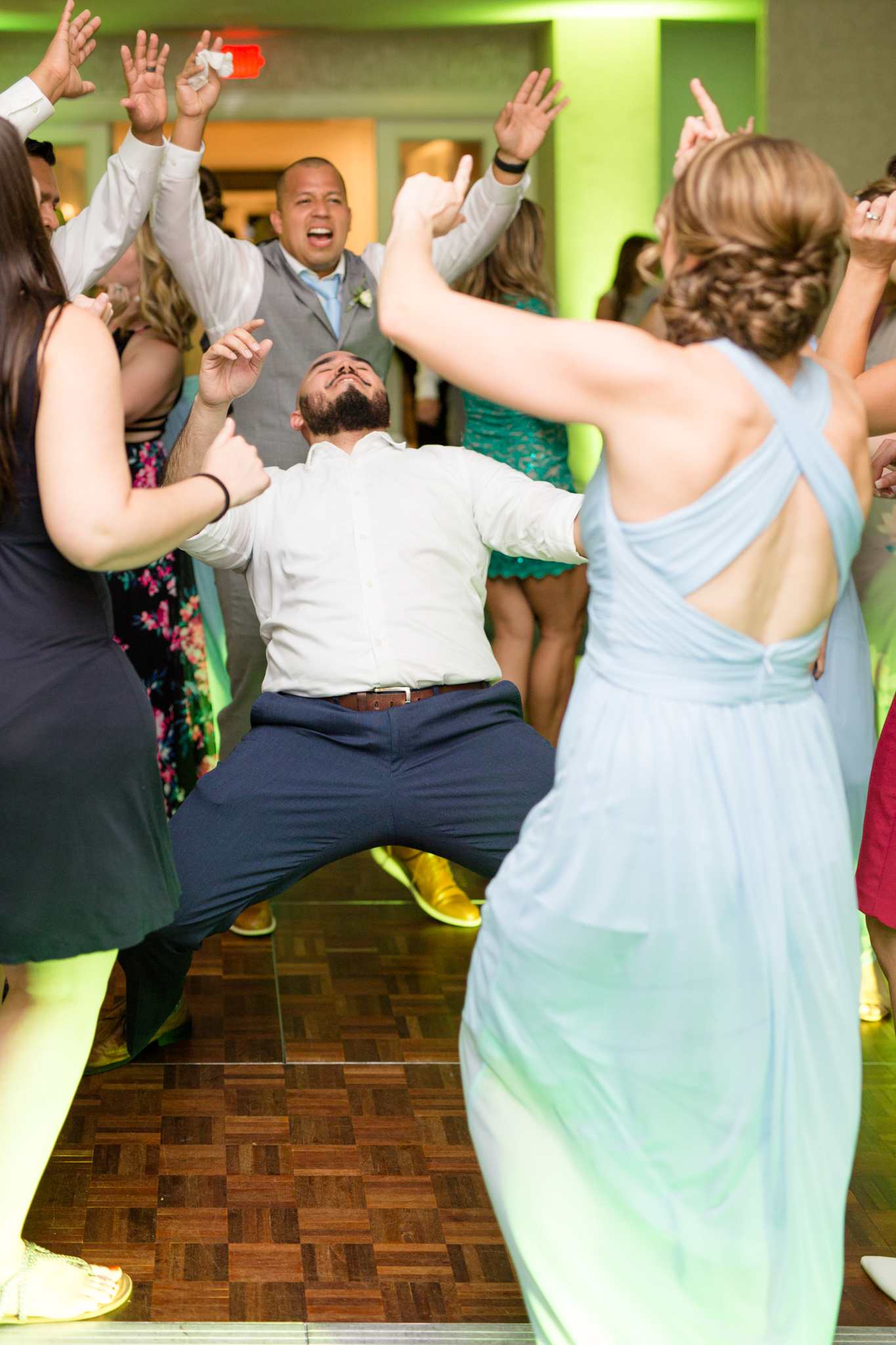 Wedding guests dance at wedding reception.