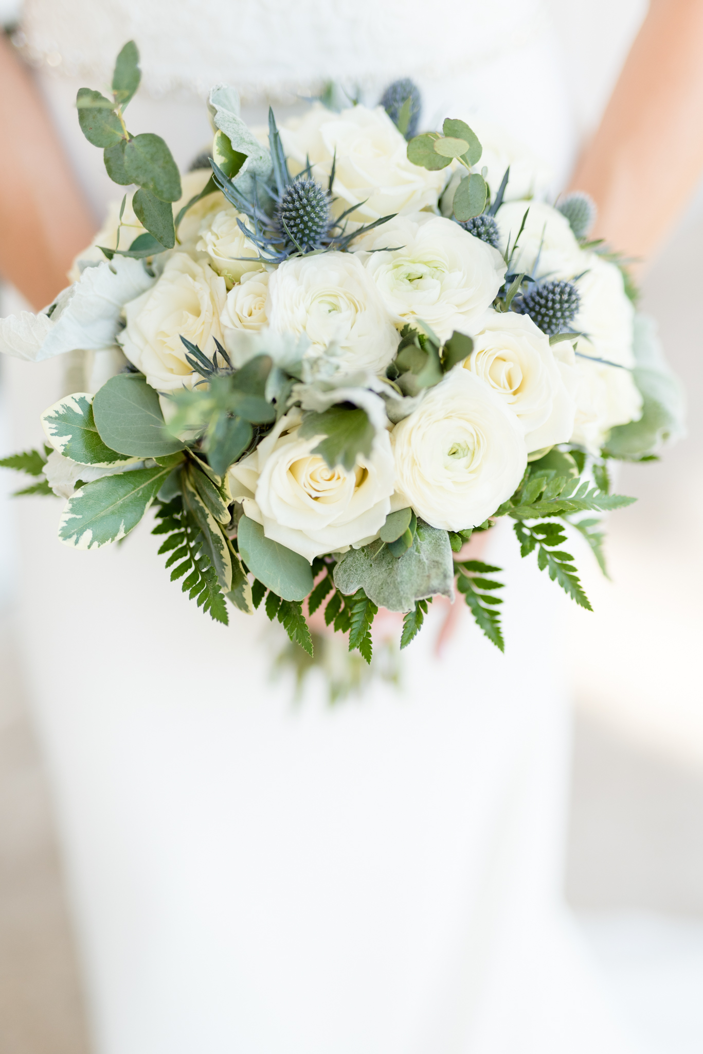 Bride holds bouquet.