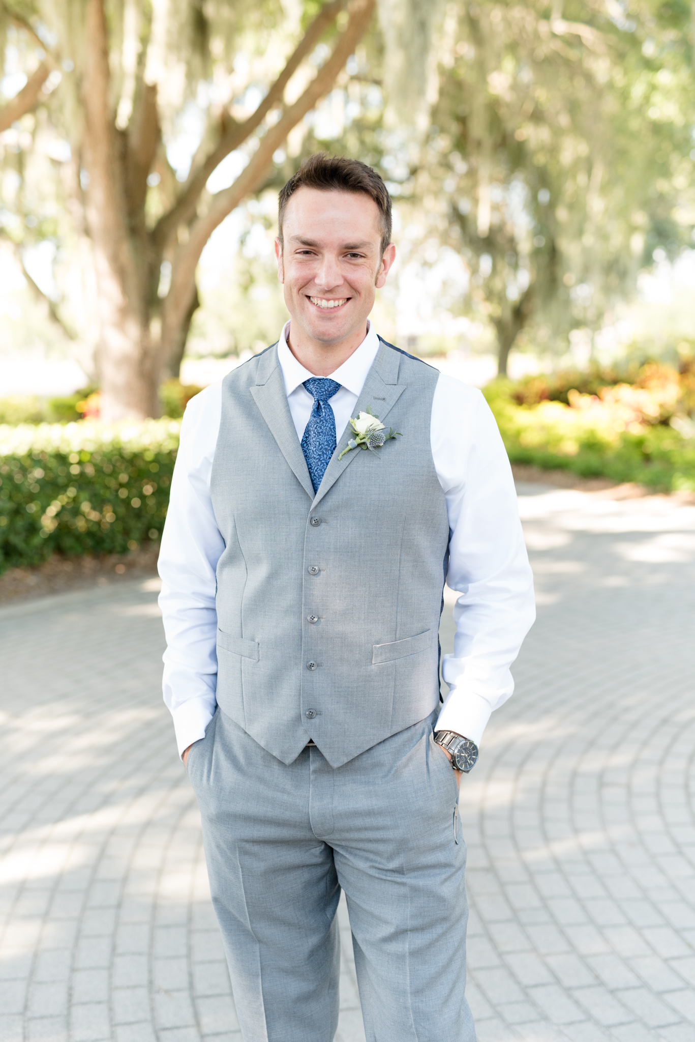Groom smiles at camera during portraits.
