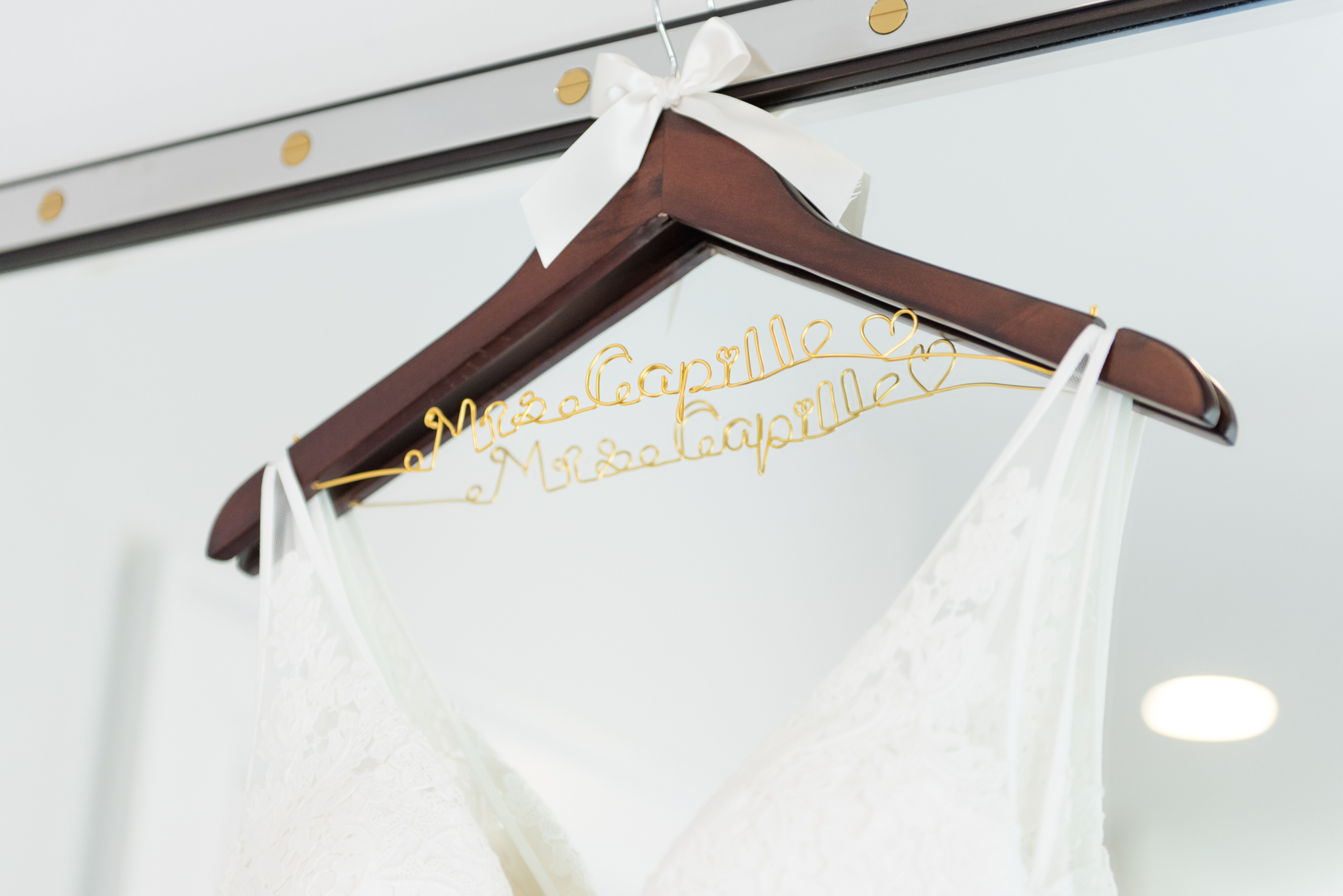 Bride's dress hangs on special hangar.
