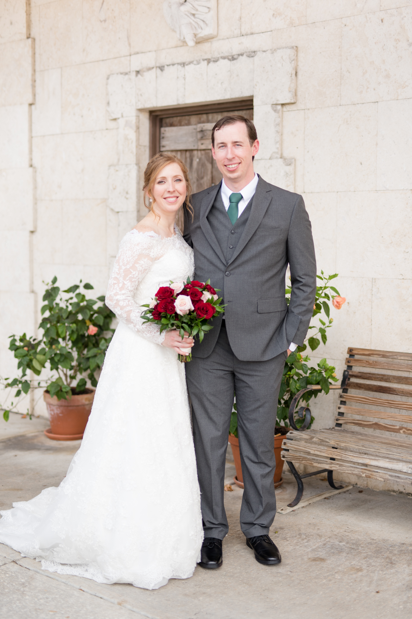 Bride and groom smile at camera.