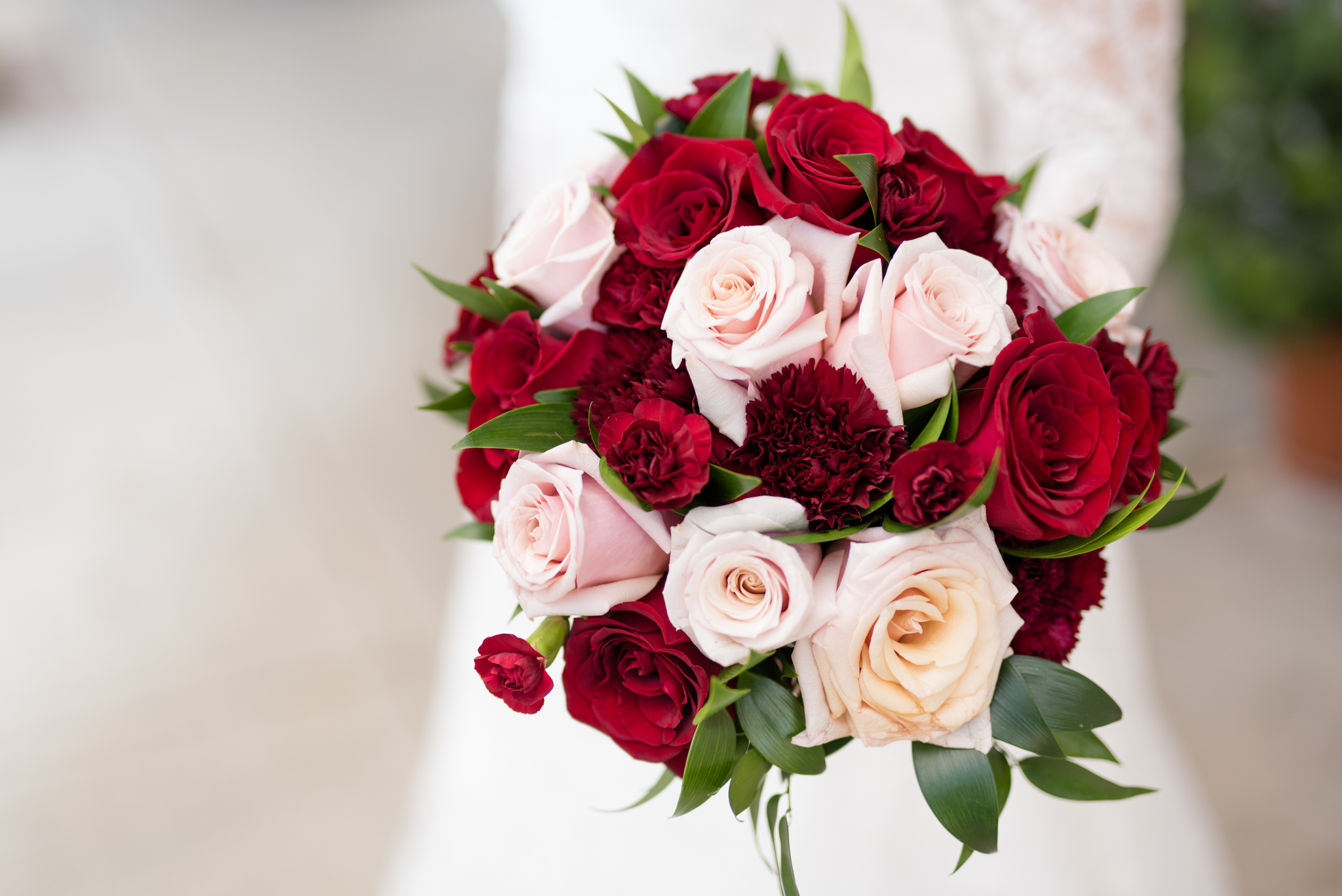 Bridal bouquet with red and pink roses.